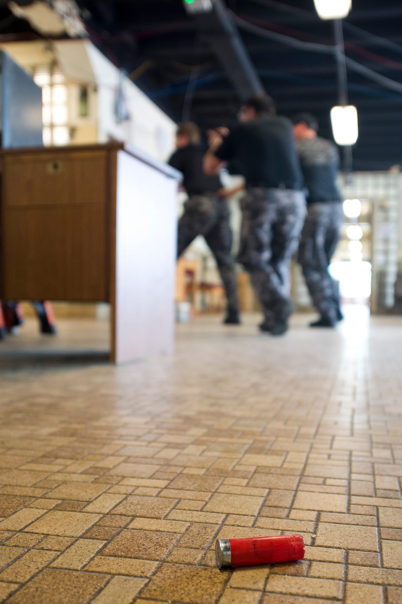 Members of the Ft. Walton Beach, Fla., Police Department SWAT team, search for an active shooter while playing the role of emergency responders during the 2015 Air Force Research Laboratory Commanders Challenge, June 17, at the Muscatatuck Urban Training Center, Butlerville,, Ind., Four members from the SWAT team participated in the challenge playing the role of emergency responders in addition to the active shooter. (U.S. Air Force photo by Wesley Farnsworth)