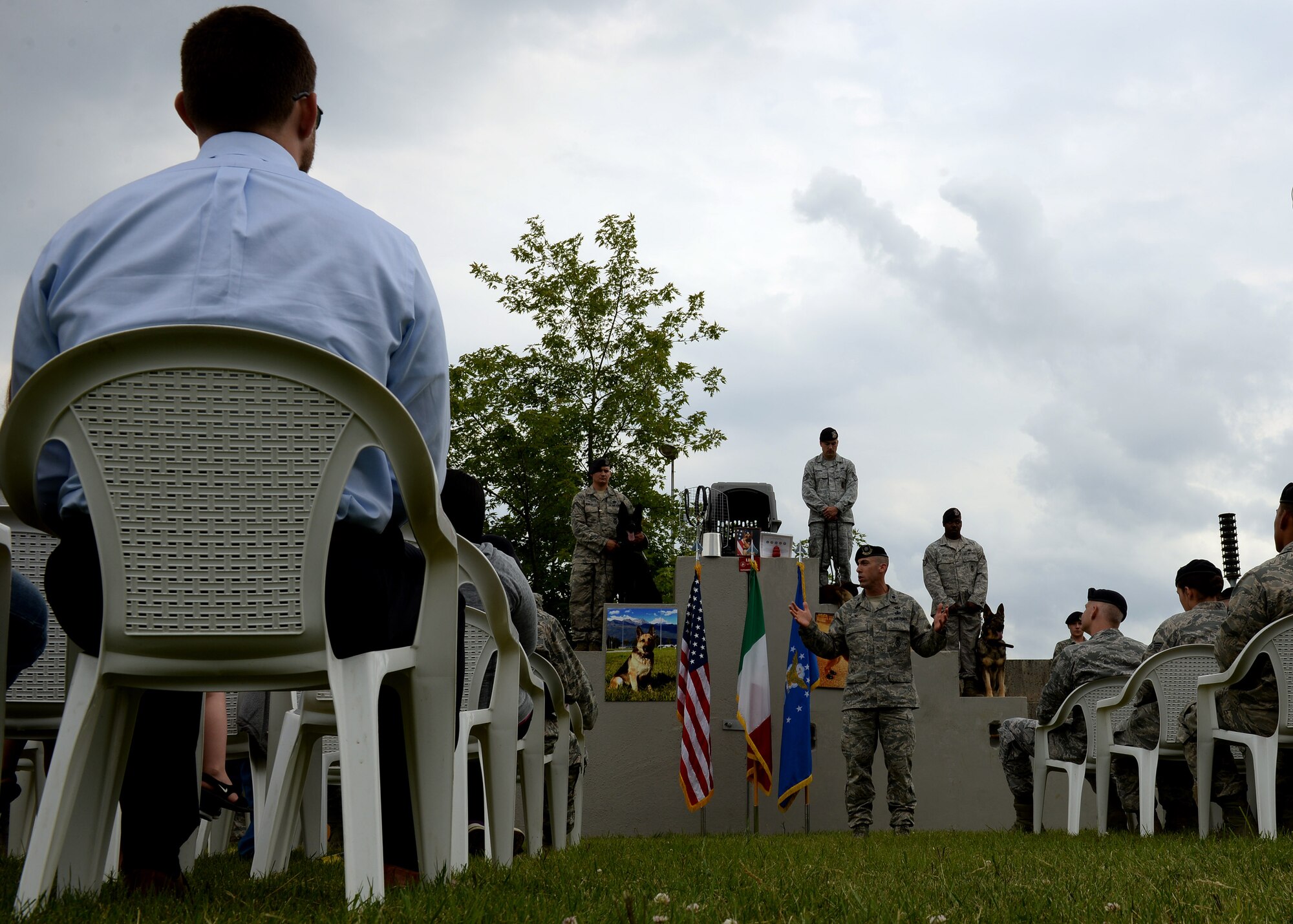 U.S. Air Force Lt. Col. Damian Schlussel, 31st Security Forces Squadron commander, speaks at a military working dog memorial and retirement ceremony, June 22, 2015, at Aviano Air Base, Italy. The memorial was for MWD Lea, who passed away. Tora, another MWD, retired at the conclusion of the ceremony. (U.S. Air Force photo by Airman 1st Class Cary Smith/Released)