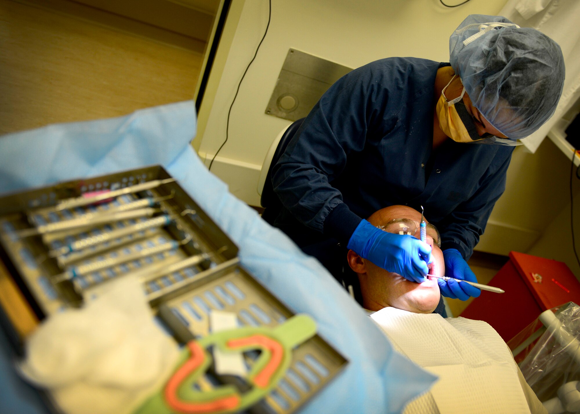 U.S. Air Force Staff Sgt. Jenna Bliss, 31st Dental Squadron dental technician, cleans the teeth of U.S. Air Force Tech. Sgt. Jason Hahn, 31st Operations Support Squadron watch supervisor, June 23, 2015, at Aviano Air Base, Italy. Dental Airmen provide dental care to more than 130 patients per week. (U.S. Air Force photo by Senior Airman Areca T. Wilson/Released)