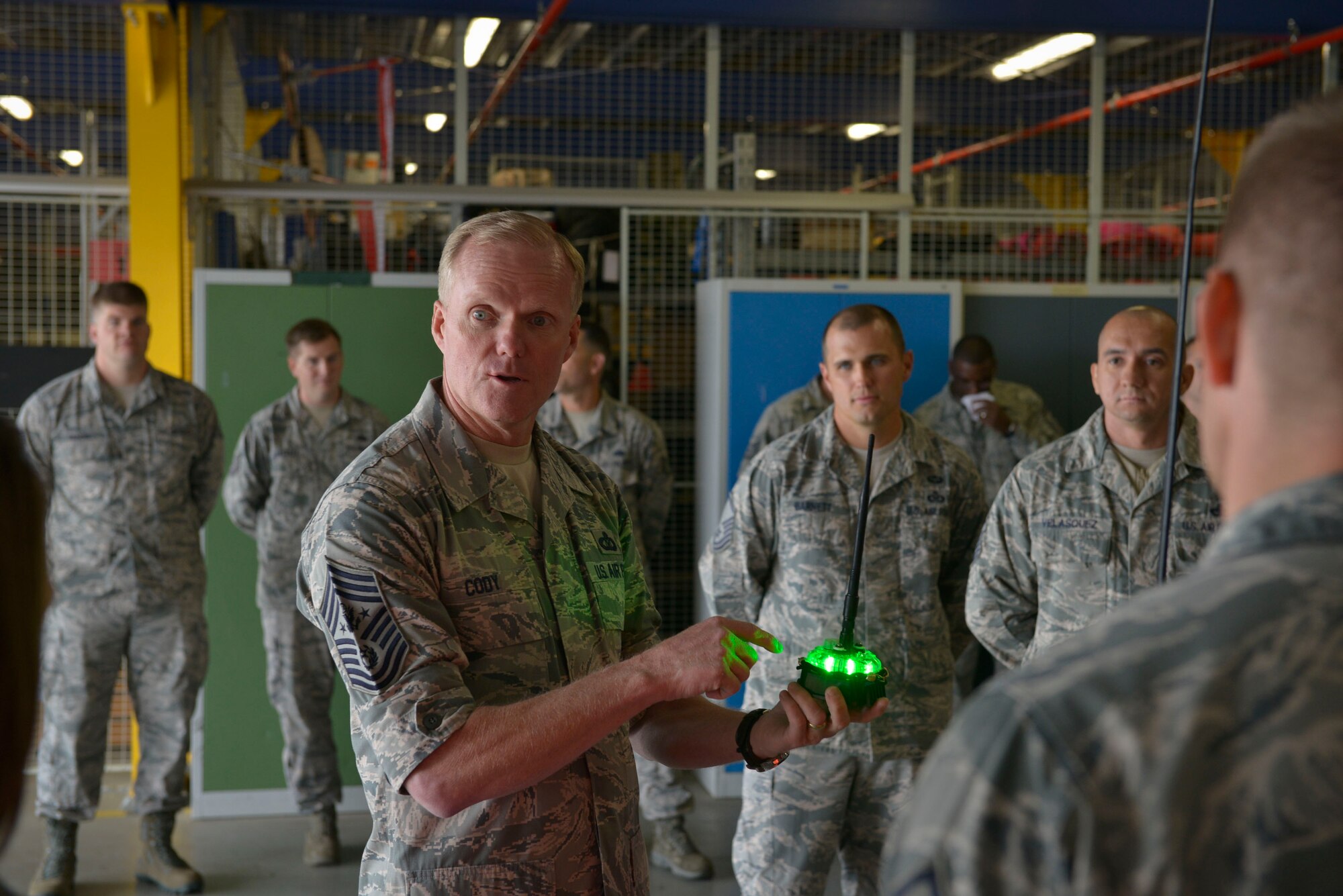 Chief Master Sgt. of the Air Force James A. Cody listens to a mission brief  during his immersion tour with the 435th Air Ground Operations Wing on Ramstein Air Base, Germany, June 22, 2015. Cody interacted with Airmen to gain more insight on the equipment they use daily. (U.S. Air Force photo by Airman 1st Class Lane T. Plummer)