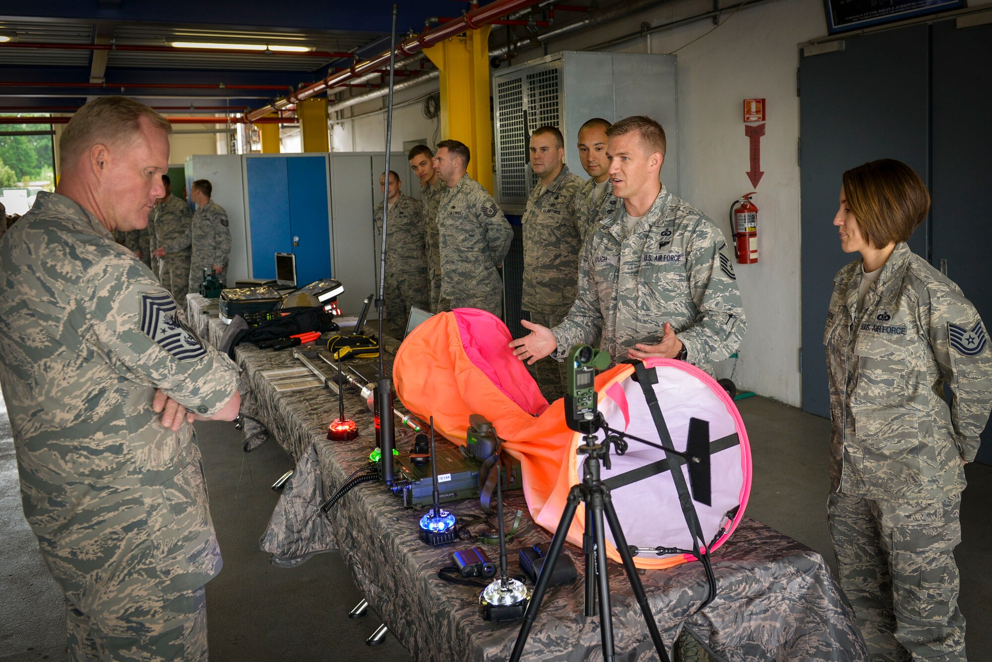 Chief Master Sgt. of the Air Force James A. Cody listens to a group of Airmen from the 435th Air Ground Operations Wing’s Air Mobility Squadron as they explain the functions of some of the equipment on display June 22, 2015, at Ramstein Air Base, Germany. Cody visited the 435th AMS to meet and greet Airmen as they provided examples of the products they use and produce on the job. (U.S. Air Force photo by Airman 1st Class Lane T. Plummer)