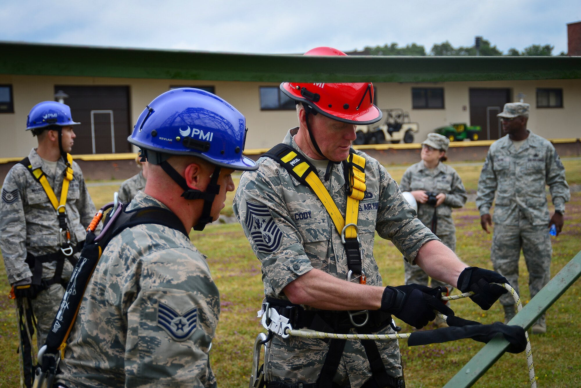 Staff Sgt. Daniel Peters, 1st Communications Maintenance Squadron cable and antenna theater maintenance supervisor, assists Chief Master Sgt. of the Air Force James A. Cody with safely donning his climbing harness June 22, 2015 on Ramstein Air Base, Germany. Cody performed a tower climb with Airmen from the 1st CMXS during his 435th Air Ground Operations Wing immersion tour.  (U.S. Air Force photo/Tech. Sgt. Daylena S. Ricks)