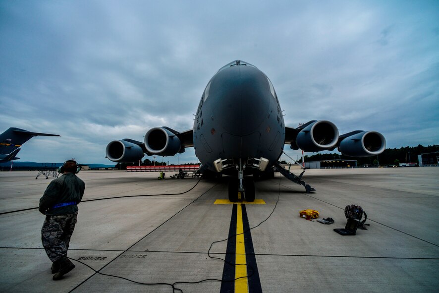 Staff Sgt. Adam Hart, 721st Aircraft Maintenance Squadron electrical and environmental systems specialist, refuels a C-17 Globemaster III before a flight to Bulgaria June 20, 2015, Ramstein Air Base, Germany.  Airmen and Soldiers worked together to load two M1A2 Abrams main battle tanks onto the aircraft. (U.S. Air Force photo/Senior Airman Nicole Sikorski) 