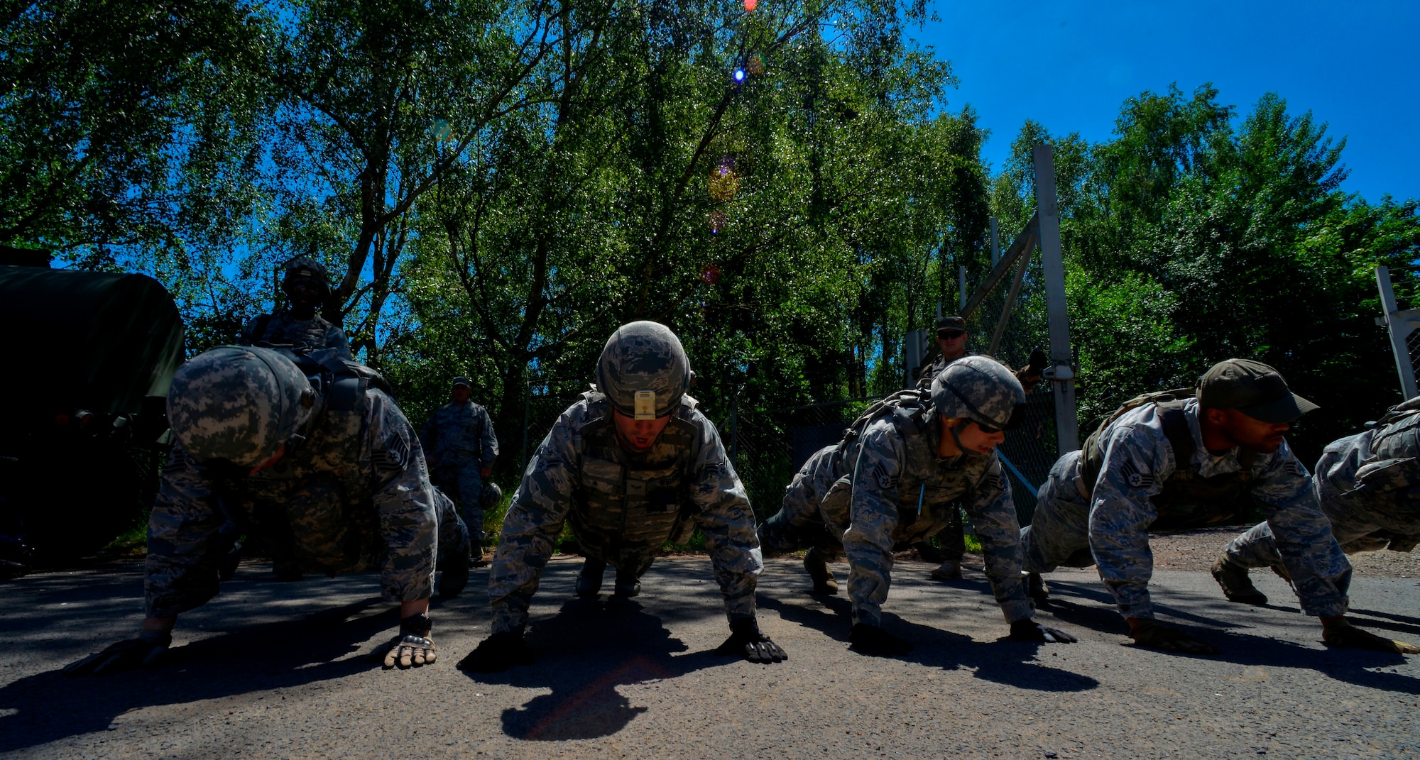 Security forces members from throughout U.S. Air Forces in Europe and Air Forces Africa perform pushups during live-fire, stress-fire training June 17, 2015 on Baumholder, Germany.  This live-fire exercise was a part of a 15-day Creek Defender’s Base Security Operations course, designed to prepare defenders for upcoming deployments. (U.S. Air Force photo/Senior Airman Nicole Sikorski)