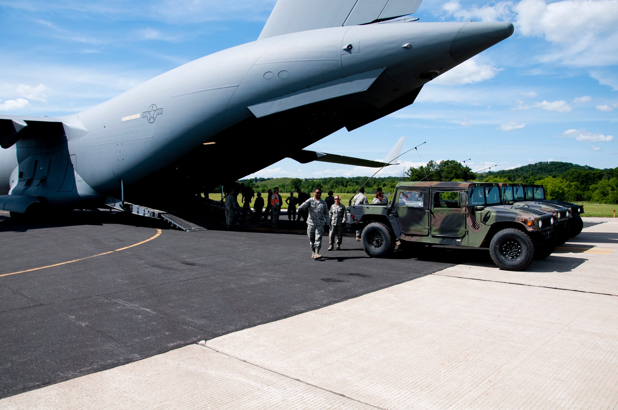 Members of the 446th Aeromedical Evacuation Squadron out of Joint Base Lewis-McChord, Wash., perform a patient on-load scenario during the Patriot Warrior exercise at Fort McCoy, Wis., June 21, 2015. Patriot Warrior is a joint exercise designed to demonstrate contingency deployment training ranging from bare base buildup to full operational capabilities. More than 6,000 members from the U.S. service branches and their Reserve components, including Air Force, Army, and Navy participated alongside British and Canadian forces. (U.S. Air Force Reserve photo by Senior Airman Daniel Liddicoet)