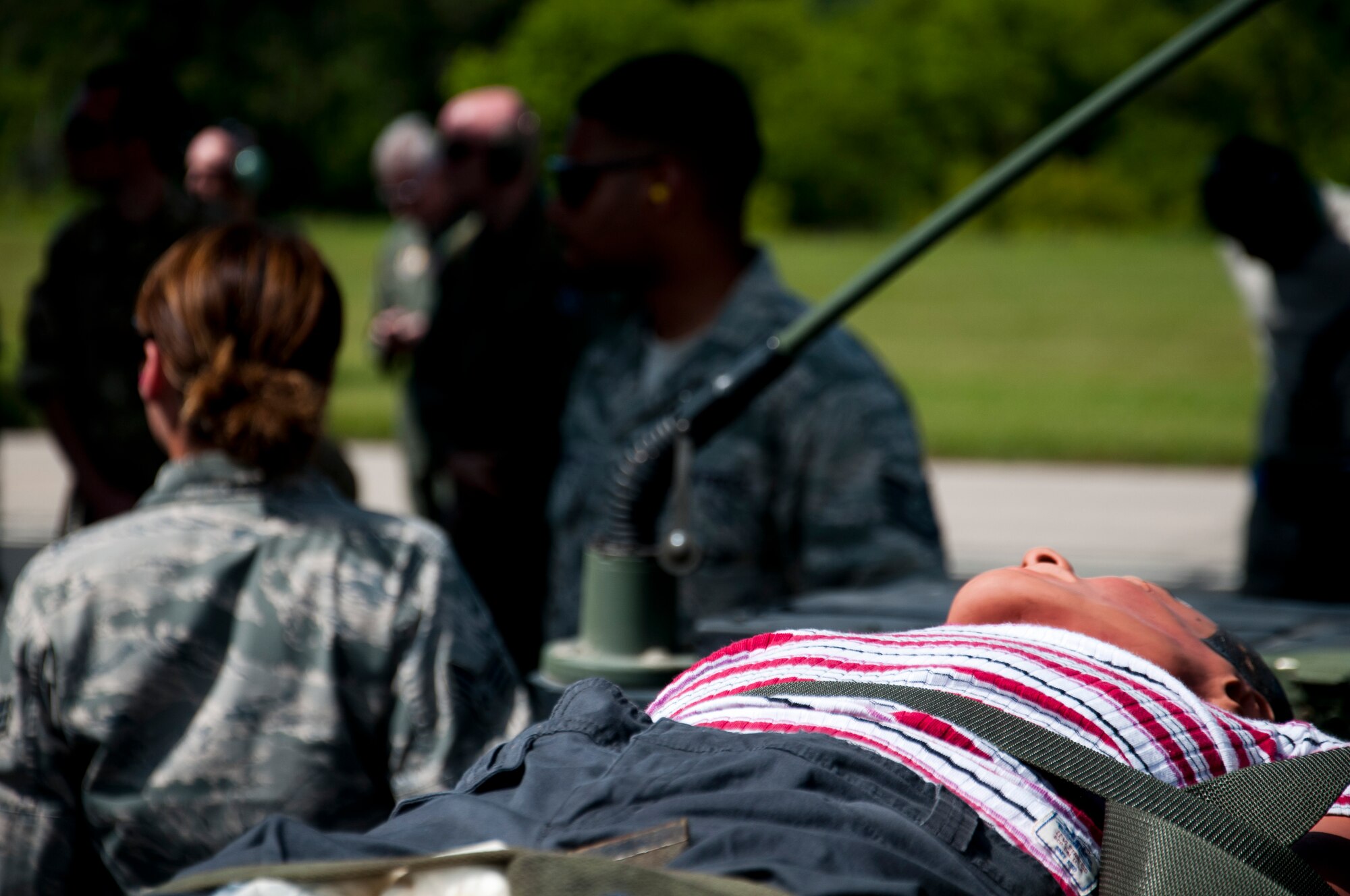 Members of the 446th Aeromedical Evacuation Squadron out of Joint Base Lewis-McChord, Wash., perform a patient on-load scenario during the Patriot Warrior exercise at Fort McCoy, Wis., June 21, 2015. Patriot Warrior is a joint exercise designed to demonstrate contingency deployment training ranging from bare base buildup to full operational capabilities. More than 6,000 members from the U.S. service branches and their Reserve components, including Air Force, Army, and Navy participated alongside British and Canadian forces. (U.S. Air Force Reserve photo by Senior Airman Daniel Liddicoet)