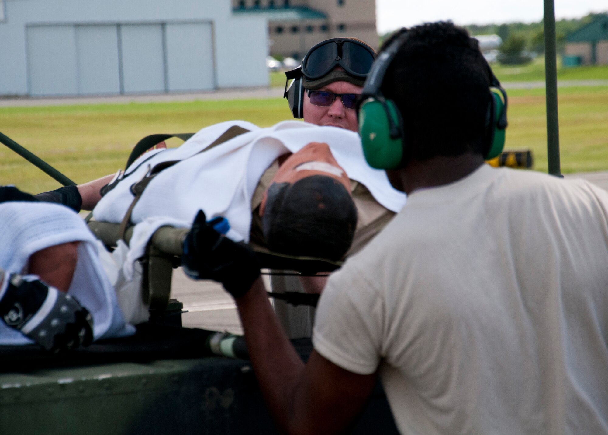 Members of the 446th Aeromedical Evacuation Squadron out of Joint Base Lewis-McChord, Wash., perform a patient on-load scenario during the Patriot Warrior exercise at Fort McCoy, Wis., June 21, 2015. Patriot Warrior is a joint exercise designed to demonstrate contingency deployment training ranging from bare base buildup to full operational capabilities. More than 6,000 members from the U.S. service branches and their Reserve components, including Air Force, Army, and Navy participated alongside British and Canadian forces. (U.S. Air Force Reserve photo by Senior Airman Daniel Liddicoet)