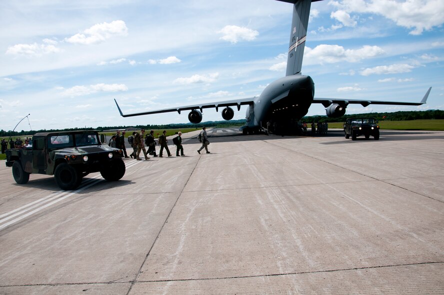 Members of the 446th Aeromedical Evacuation Squadron out of Joint Base Lewis-McChord, Wash., perform a patient on-load scenario during the Patriot Warrior exercise at Fort McCoy, Wis., June 21, 2015. Patriot Warrior is a joint exercise designed to demonstrate contingency deployment training ranging from bare base buildup to full operational capabilities. More than 6,000 members from the U.S. service branches and their Reserve components, including Air Force, Army, and Navy participated alongside British and Canadian forces. (U.S. Air Force Reserve photo by Senior Airman Daniel Liddicoet)