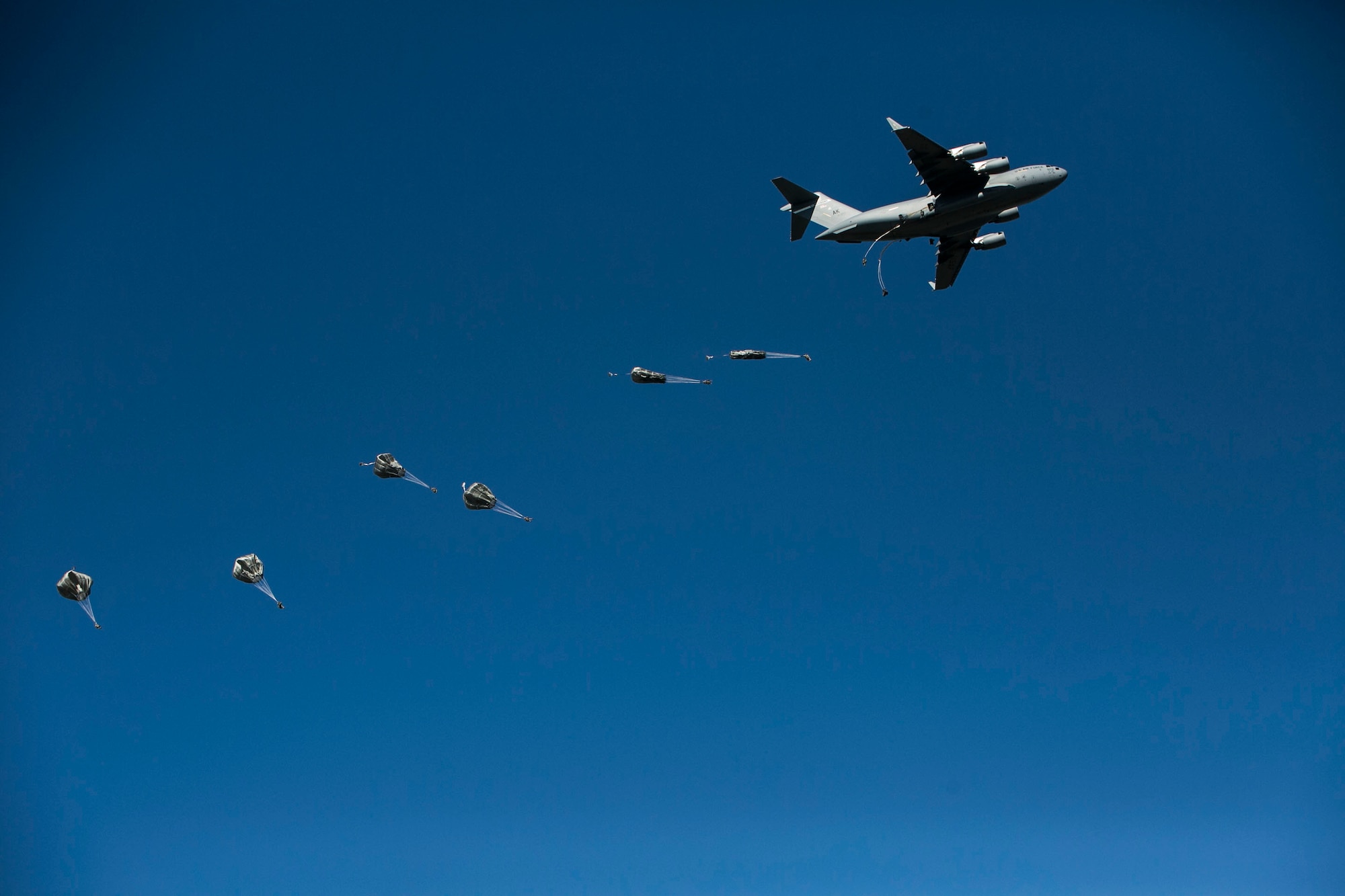 EIELSON AIR FORCE BASE, Alaska – U.S. Army engineers and combat engineers with the 6th Brigade Engineer Battalion, 4th Brigade Combat Team (Airborne), 25th Infantry Division, jump out of a U.S. Air Force C-17 Globemaster III aircraft into Allen Army Airfield at Fort Greely, Alaska, as part of Exercise Northern Edge, June 17, 2015. Northern Edge 2015 is Alaska’s premier joint training exercise designed to practice operations, techniques and procedures as well as enhance interoperability among the services. Thousands Airmen, Soldiers, Sailors, Marines and Coast Guardsmen from active duty, reserve and National Guard units are involved.  (U.S. Marine Corps photo by Cpl. Tyler S. Giguere/Released)