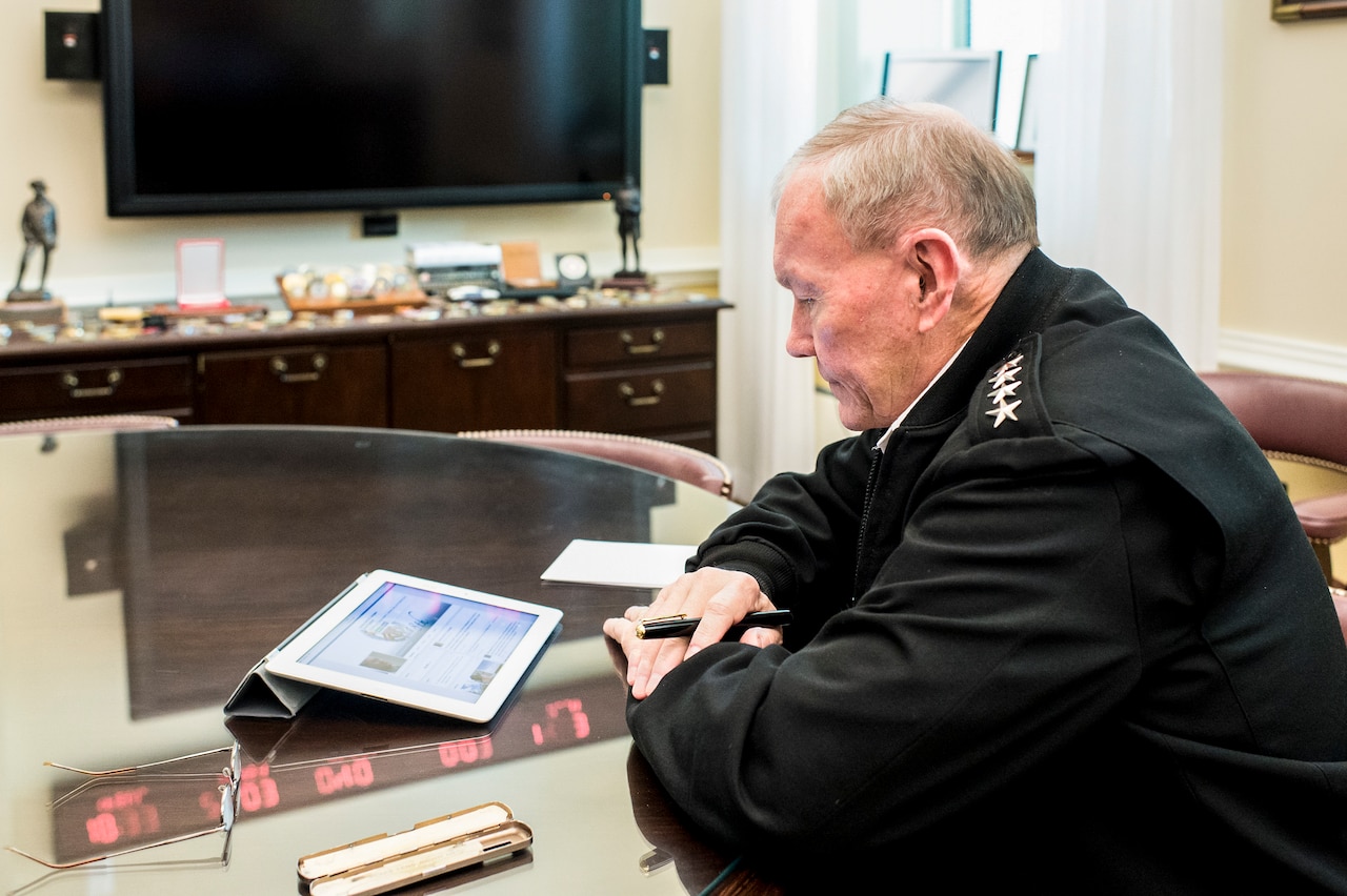 Army Gen. Martin E. Dempsey, chairman of the Joint Chiefs of Staff, sits at his desk in the Pentagon preparing for a Facebook town hall, June 24, 2015. The chairman holds periodic chats with the military world at large via social media. His first was in December 2013. DoD photo by U.S. Navy Petty Officer 1st Class Daniel Hinton
