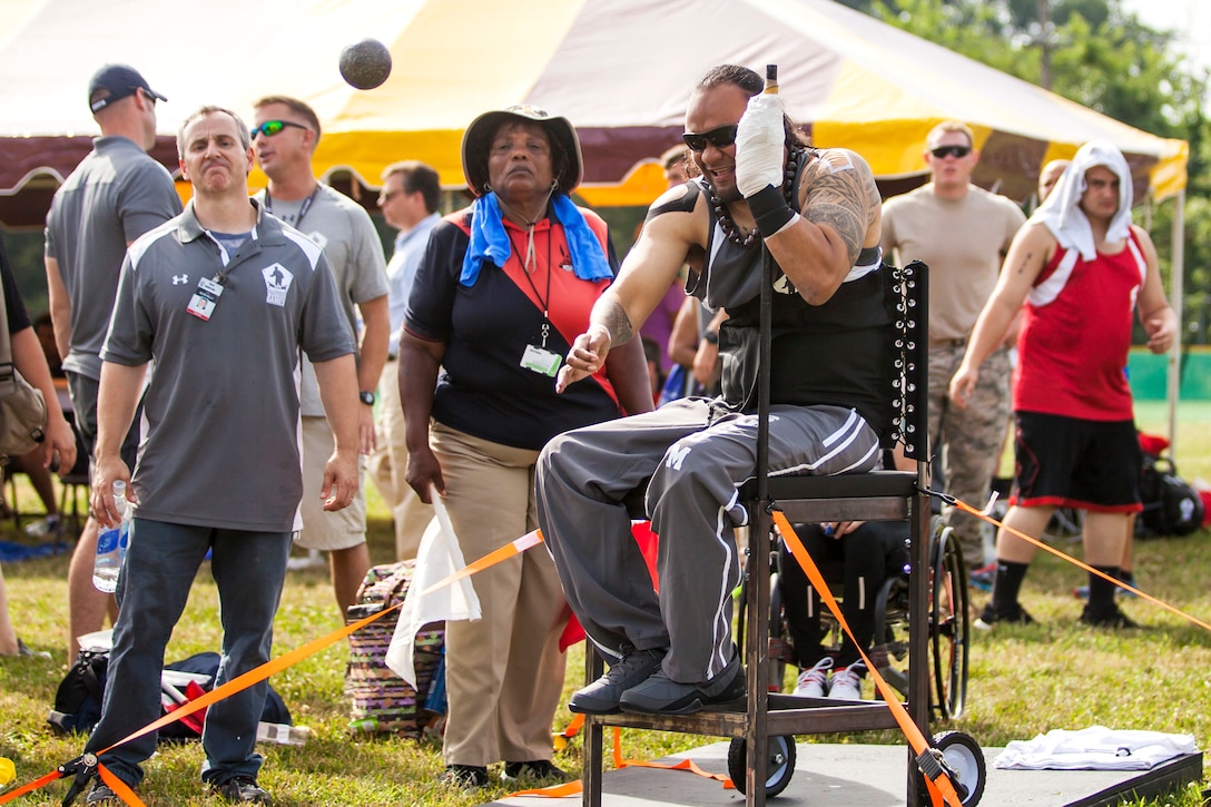 U.S. Army veteran Sgt. 1st Class Sualauvi Tuimalealiifano throws the ...