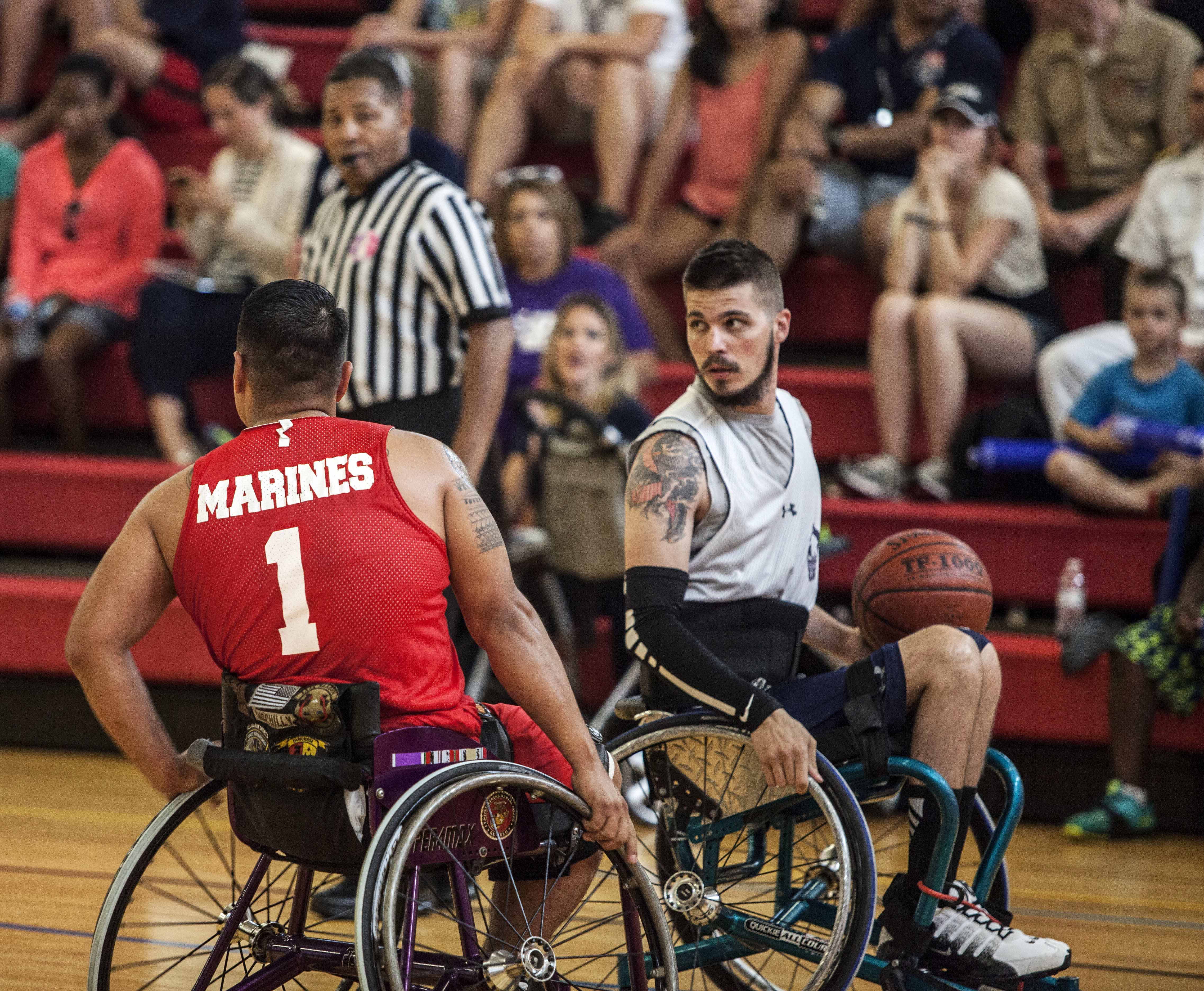 U.S. Marine Corps veteran Marcus Chischilly left plays defense