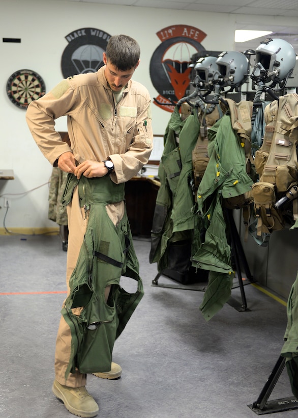 U.S. Air Force Capt. Dakota Olsen puts on his flight suit before participating in a combat airpower mission on Bagram Airfield, Afghanistan, June 17, 2015.