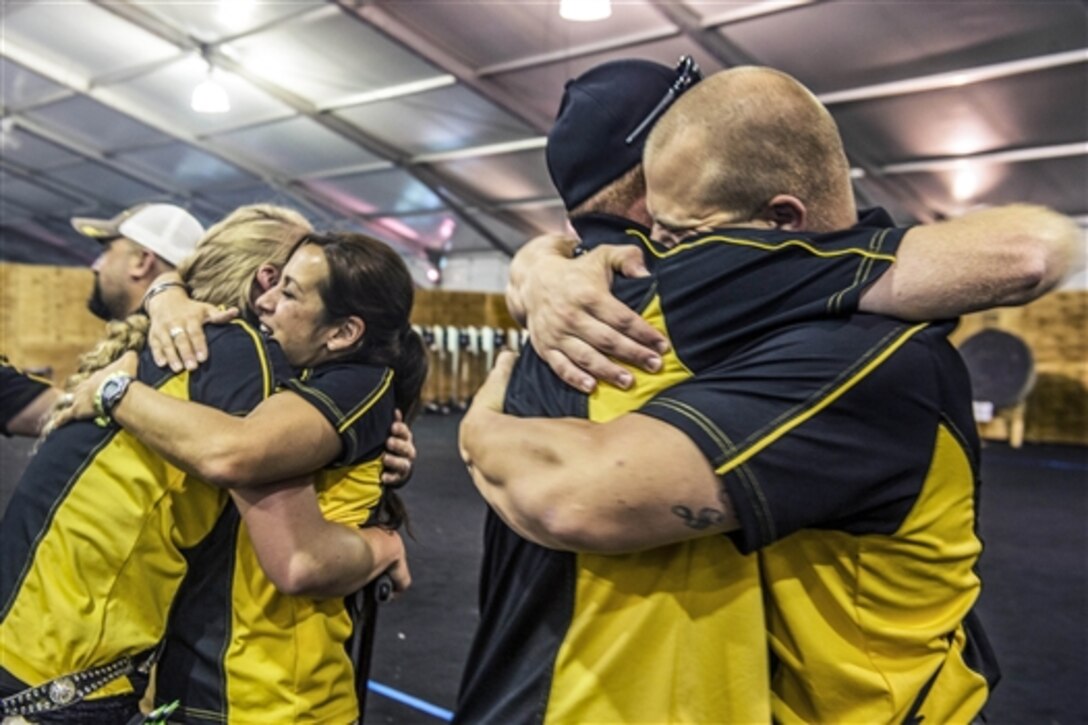 Team Army members celebrate after winning the gold medal for both the team compound and recurve events during the archery competition at the 2015 Department of Defense Warrior Games on Marine Corps Base Quantico, Va., June 22, 2015.