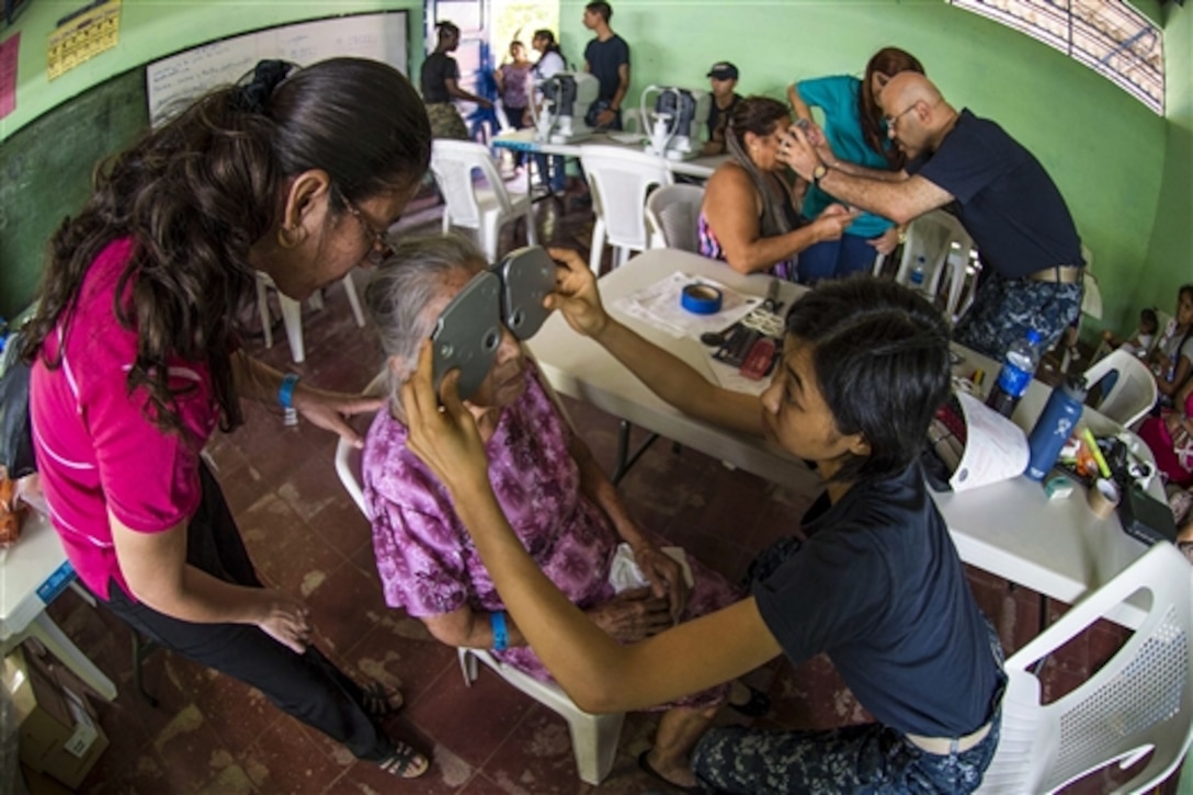 U.S. Navy Lt. Serena Leung and Lt. Cmdr. William Hill conduct eye exams at a medical site established during Continuing Promise 2015 in Acajutla, El Salvador, June 21, 2015. Leung is an optometrist assigned to Naval Hospital Camp Lejeune, N.C. Hill, also an optometrist, is assigned to Naval Medical Center Portsmouth, Va.