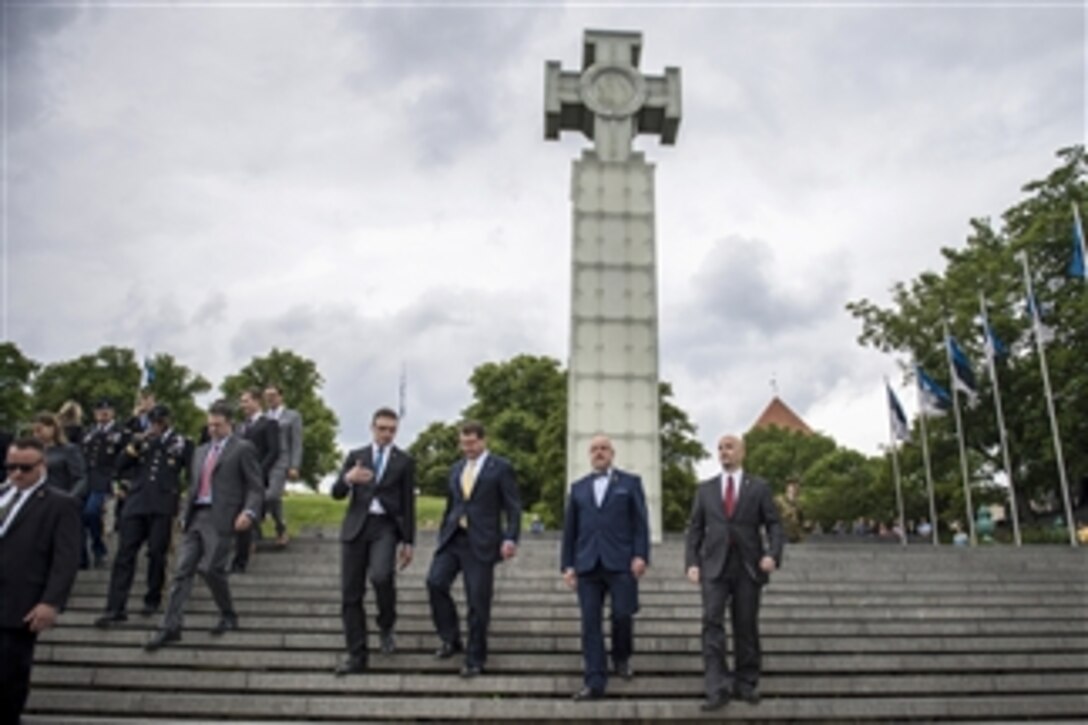 U.S. Defense Secretary Ash Carter, second from left, departs the War of Independence Victory Column with Estonian Defense Minister Sven Mikser, left, Lithuanian Defense Minister Juozas Olekas, second from right, and Latvian Defense Secretary Janis Sarts after participating in a wreath-laying ceremony in Tallinn, Estonia.