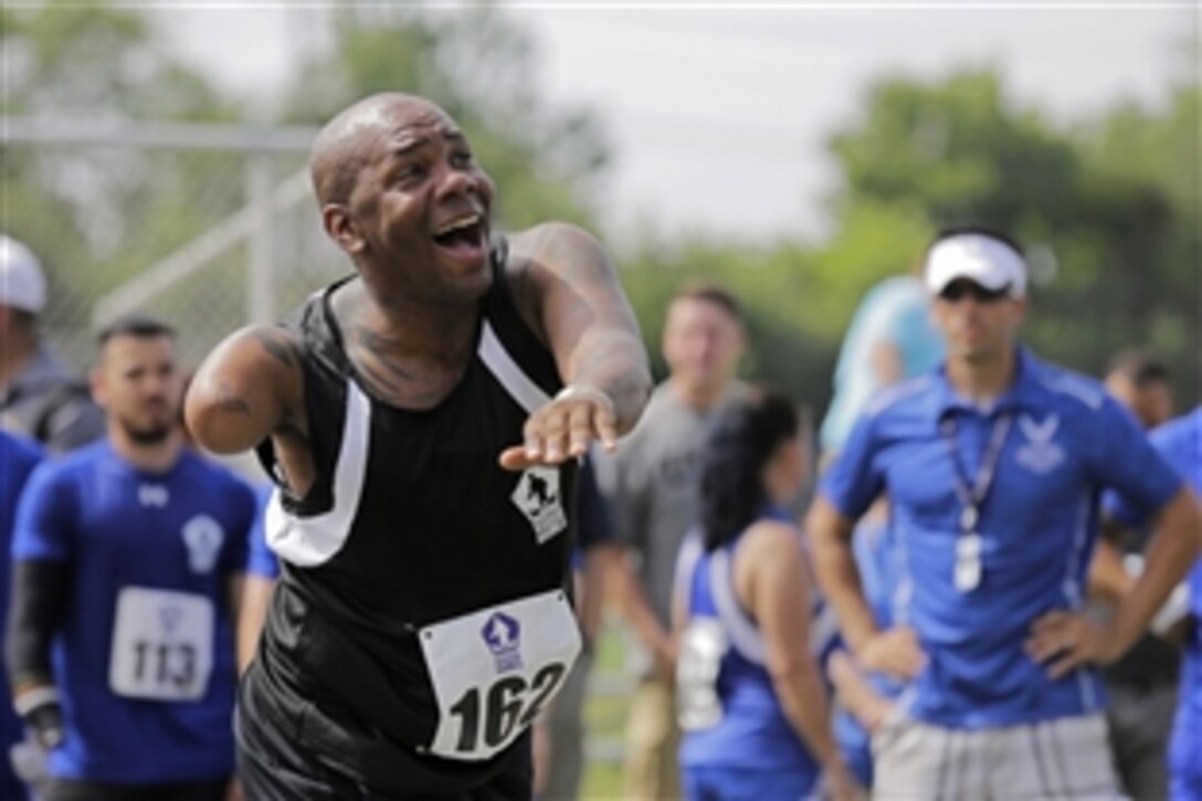 U.S. Army Sgt. 1st Class Michael Smith puts all his energy into his second throw of the day during the men's shot put competition at the 2015 Department of Defense Warrior Games on Marine Corps Base Quantico, Va., June 23, 2015.