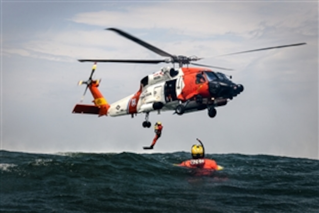 Coast Guardsmen practice hoisting procedures off the coast of Boston in the Atlantic Ocean, June 23, 2015. The guardsmen are rescue swimmers and aircrewmen assigned to Coast Guard Air Station Cape Cod, Mass.