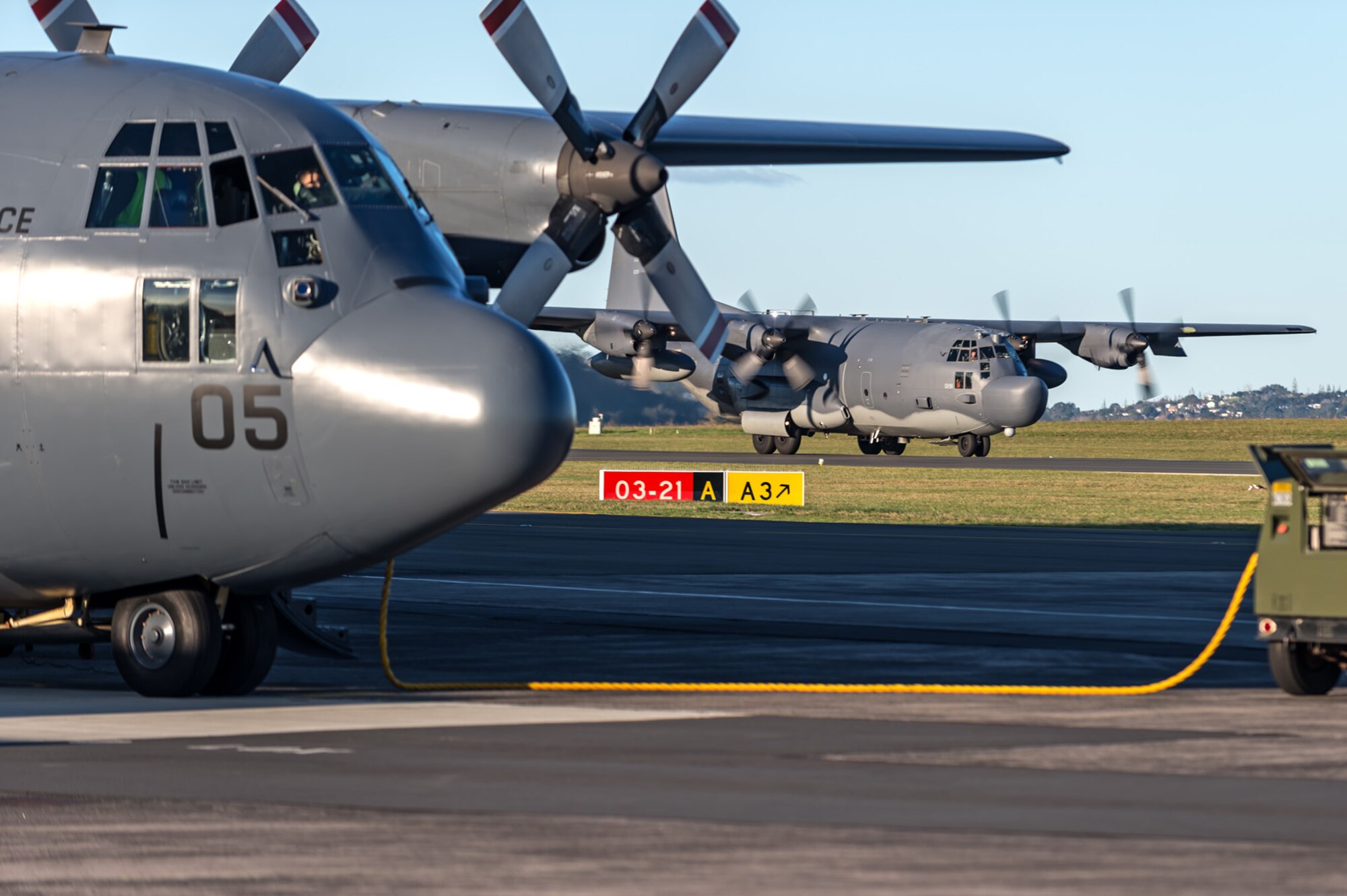 A U.S. Air Force MC-130H Combat Talon II from the 1st Special Operations Squadron taxis after landing at Royal New Zealand Air Force Base Auckland, New Zealand, June 16, 2015 while a Royal New Zealand Air Force C-130H(NZ) Hercules sits in the foreground.  Members from the 353rd Special Operations Group and the Royal New Zealand Air Force and Army are participating in Exercise Flash Lantern Net June 18-27 at RNZAF Base Auckland in New Zealand.    (New Zealand Defense Force photo by Roderick Mackenzie\Released)

