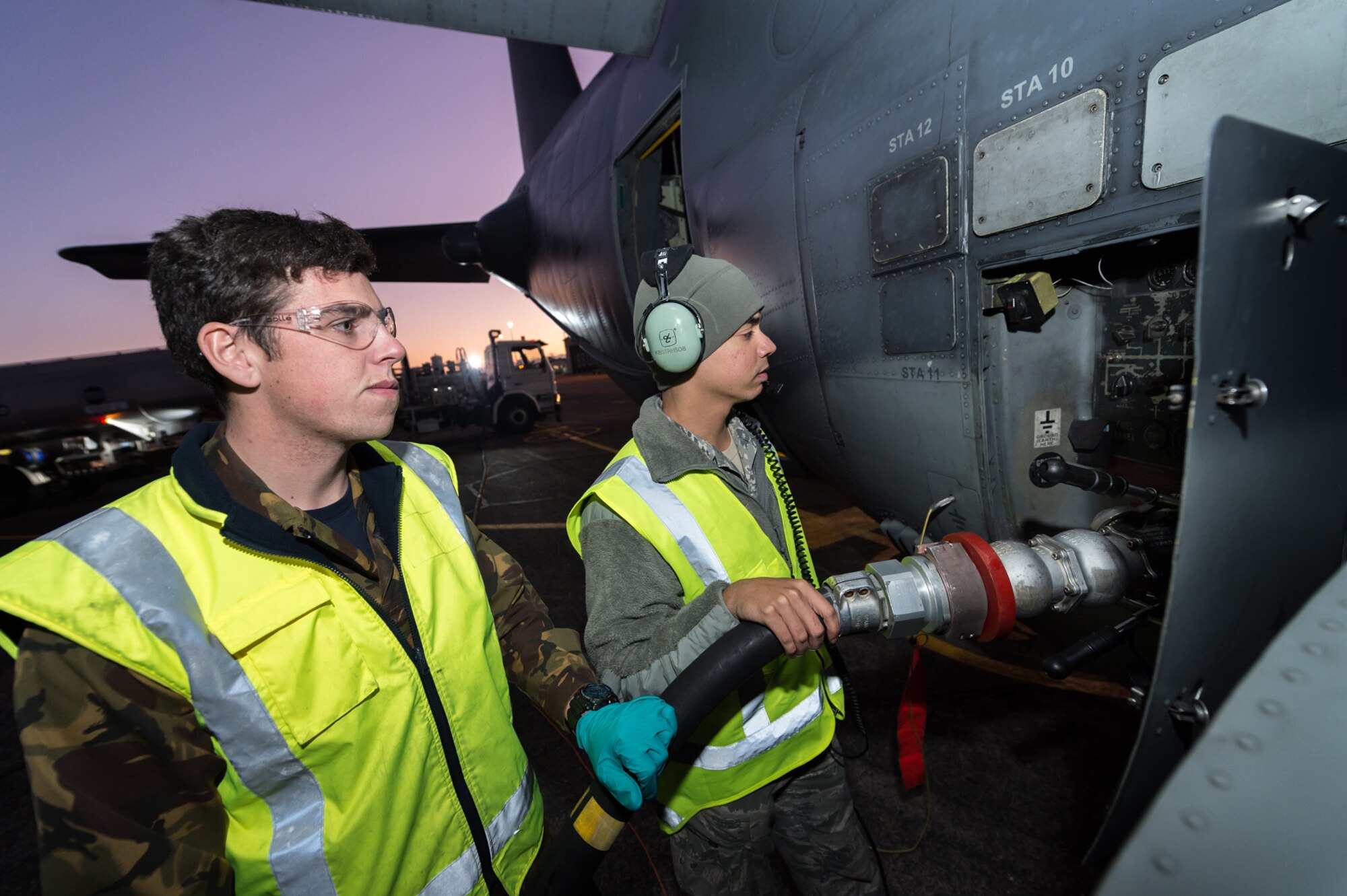 Royal New Zealand Air Force Aviation Refueller AC Conrad Hazelwood (left) and U.S. Air Force Senior Airman Luke-Nathan De Jesus (right) refuel a 1st Special Operations Squadorn MC-130H Combat Talon II aircraft on the flight line June 16, 2015 at RNZAF Base Auckland, New Zealand.  Members from the 353rd Special Operations Group and the Royal New Zealand Air Force and Army are participating in Exercise Flash Lantern Net June 18-27 at RNZAF Base Auckland in New Zealand. (New Zealand Defense Force photo by Roderick Mackenzie\Released)
