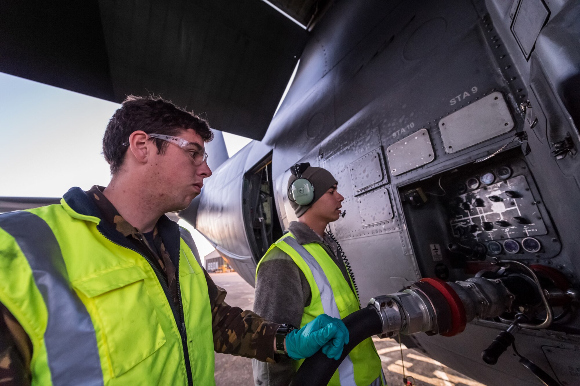 Royal New Zealand Air Force Aviation Refueler AC Conrad Hazelwood (left) and U.S. Air Force Senior Airman Luke-Nathan De Jesus, (right) 353rd Special Operations Maintenance Squadron, refuel a 1st Special Operations Squadron MC-130H Combat Talon II aircraft on the flight line June 16, 2015 at RNZAF Base Auckland, New Zealand.  Members from the 353rd Special Operations Group and the Royal New Zealand Air Force and Army are participating in Exercise Flash Lantern Net June 18-27 at RNZAF Base Auckland in New Zealand. (New Zealand Defense Force photo by Roderick Mackenzie)
