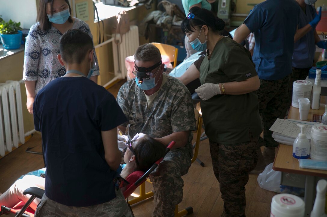 Mongolian and U.S. service members provide dental care for Mongolian residents as part of the health services support engagement during Khaan Quest 2015 at the 79th High School in Ulaanbaatar, Mongolia, June 21. Khaan Quest is a regularly scheduled, multinational exercise hosted annually by the Mongolian Armed Forces and co-sponsored by U.S. Army, Pacific, and U.S. Marine Corps Forces, Pacific. 