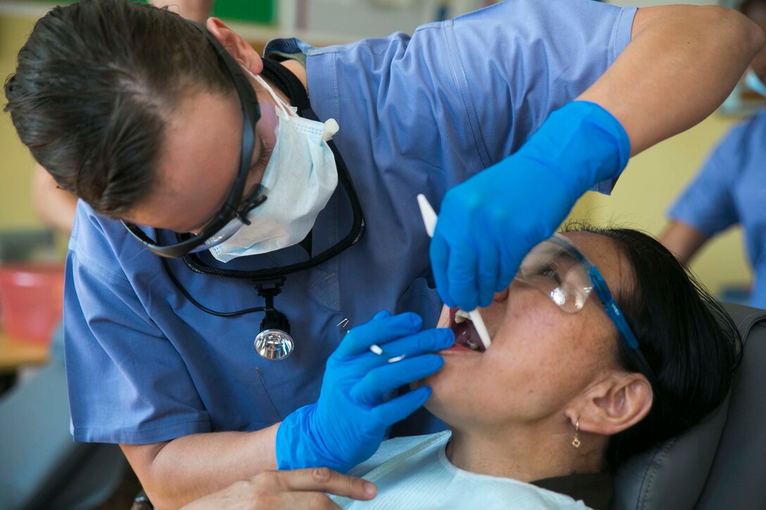 U.S. Navy Lt. Melissa Thomas, left, administers dental care to a Mongolian resident as part of the health services support engagement during Khaan Quest 2015 at the 79th High School in Ulaanbaatar, Mongolia, June 21. Khaan Quest is a regularly scheduled, multinational exercise hosted annually by the Mongolian Armed Forces and co-sponsored by U.S. Army, Pacific, and U.S. Marine Corps Forces, Pacific. Thomas is a dental officer with 3rd Dental Battalion, 3rd Marine Logistics Group, III Marine Expeditionary Force. 