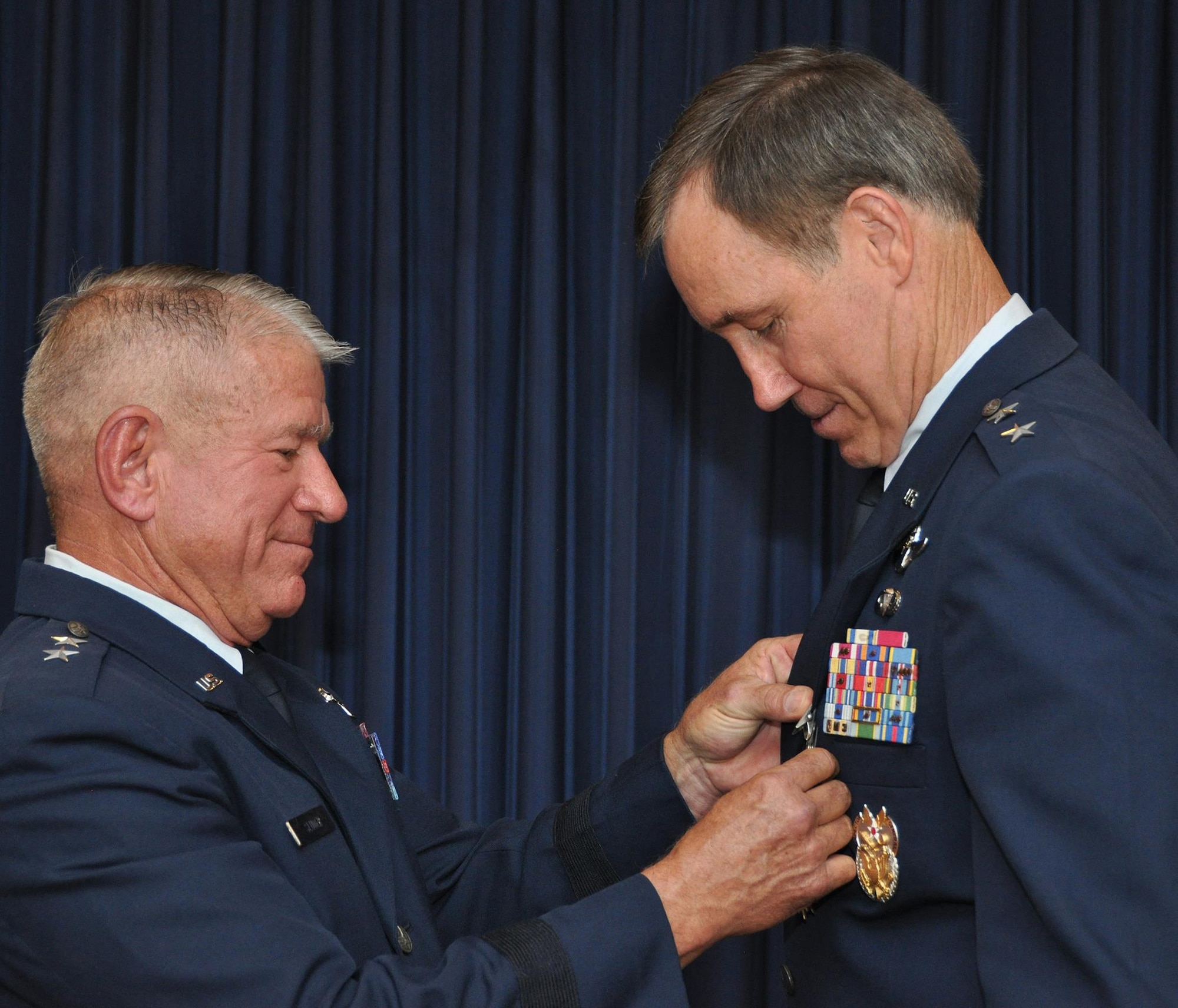 Maj. Gen. Craig Gourley (right) receives the Legion of Merit award from Maj. Gen. (ret) James Sluder, long time friend and comrade-in-arms, June 5 at the Naval Air Station Fort Worth Joint Reserve Base, Texas. Gourley served as the Deputy Inspector General of the Air Force, Office of the Secretary of the Air Force, Washington, D.C. Prior to that he was the vice commander for Air Force Reserve Command at Robins Air Force Base, Ga. He retired after 37 years of service to his country. (U.S. Air Force photo by Master Sgt. Julie Briden-Garcia)