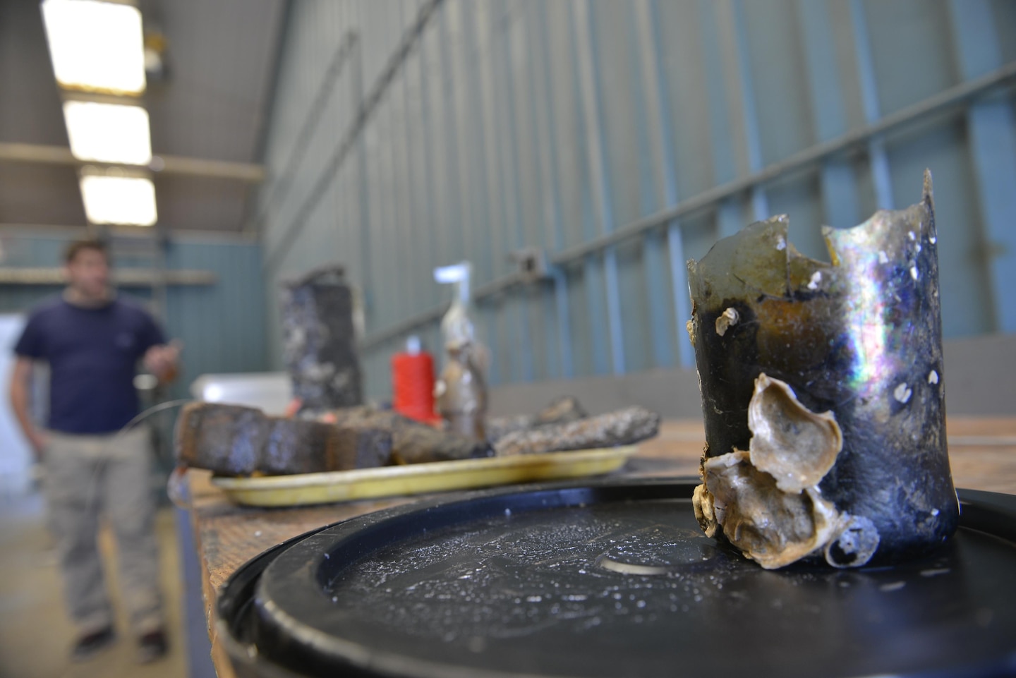 Bottle: A bottle, most likely used to hold wine, is partially covered with barnacles and marine growth.