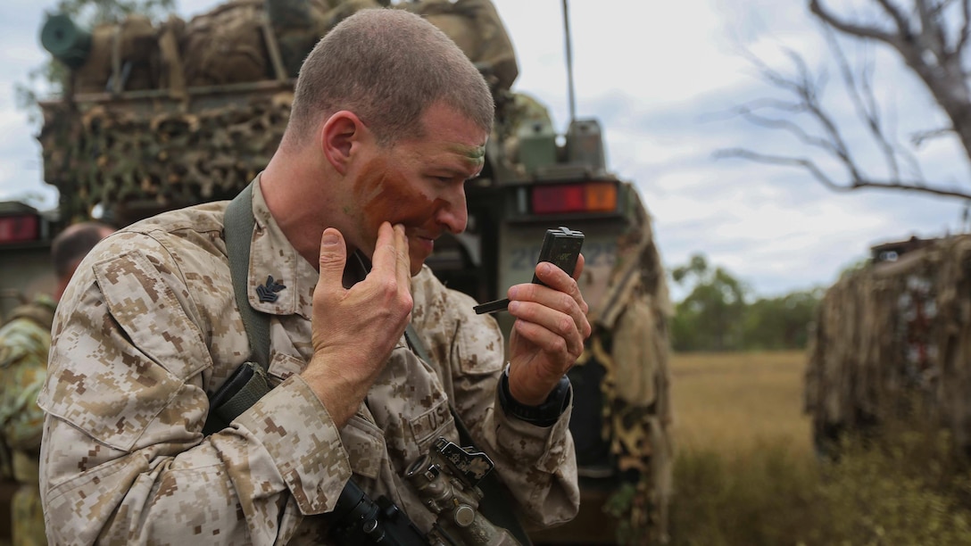 U.S. Navy Hospital Corpsman 1st Class Adam Zani, with 1st Battalion, 4th Marine Regiment, Marine Rotational Force – Darwin, applies camouflage face paint during Exercise Southern Jackaroo May 3 at Townsville Field Training Area, Queensland, Australia. SJ15 is a bilateral training exercise between soldiers from Company A, 3rd Battalion, The Royal Australian Regiment, Australian Army, Australian Defence Force, and the Marines with MRF-D. The rotational deployment of U.S. Marines in Australia affords an unprecedented combined training opportunity with their Australian allies and improves interoperability between the two forces. 