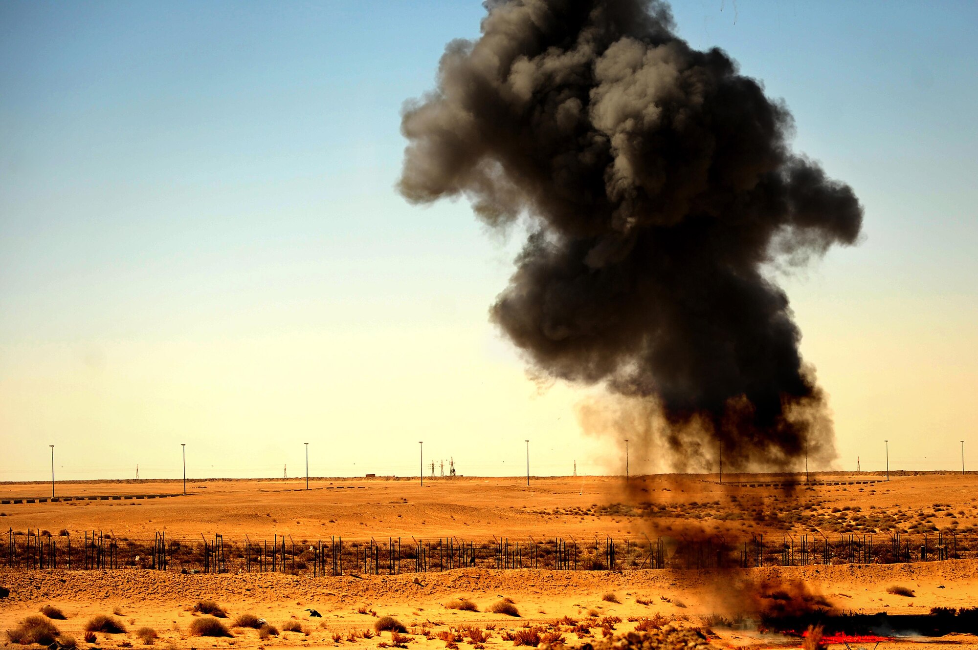 386th Expeditionary Civil Engineer Squadron explosive ordnance disposal technicians detonate an explosive during a training exercise at an undisclosed location in Southwest Asia, June 25, 2015.  EOD technicians routinely train to sharpen their skills to detect, identify, recover and dispose of explosives and ordnance that are unsafe. (U.S. Air Force photo/Tech. Sgt. Brittany E. Jones)