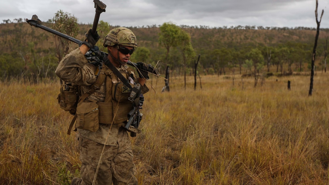 U.S. Marine Corps Lance Cpl. Chris Ringstaff sprints with a M240B medium machine gun tripod mount during a brigade assault as part of Exercise Southern Jackaroo  June 13 at Townsville Field Training Area, Queensland, Australia. SJ15 was a combined training opportunity for the Marines with Marine Rotational Force – Darwin and their Australian allies that helped to improve interoperability between the two forces. The U.S. Marine Corps and the Australian Defence Forces are committed to continuing their tradition of more than 100 years of global partnership and security cooperation between Australia and the United States of America. Ringstaff is a machine gunner with Company C, 1st Battalion, 4th Marine Regiment, MRF-D. 