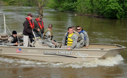 A team of Illinois Army National Guard Soldiers, with the 2nd Battalion, 130th Infantry Regiment are taken by a Sheriff Department's boat to the water and sewer treatment facility in Murphysboro, Ill. April 30, 2011.