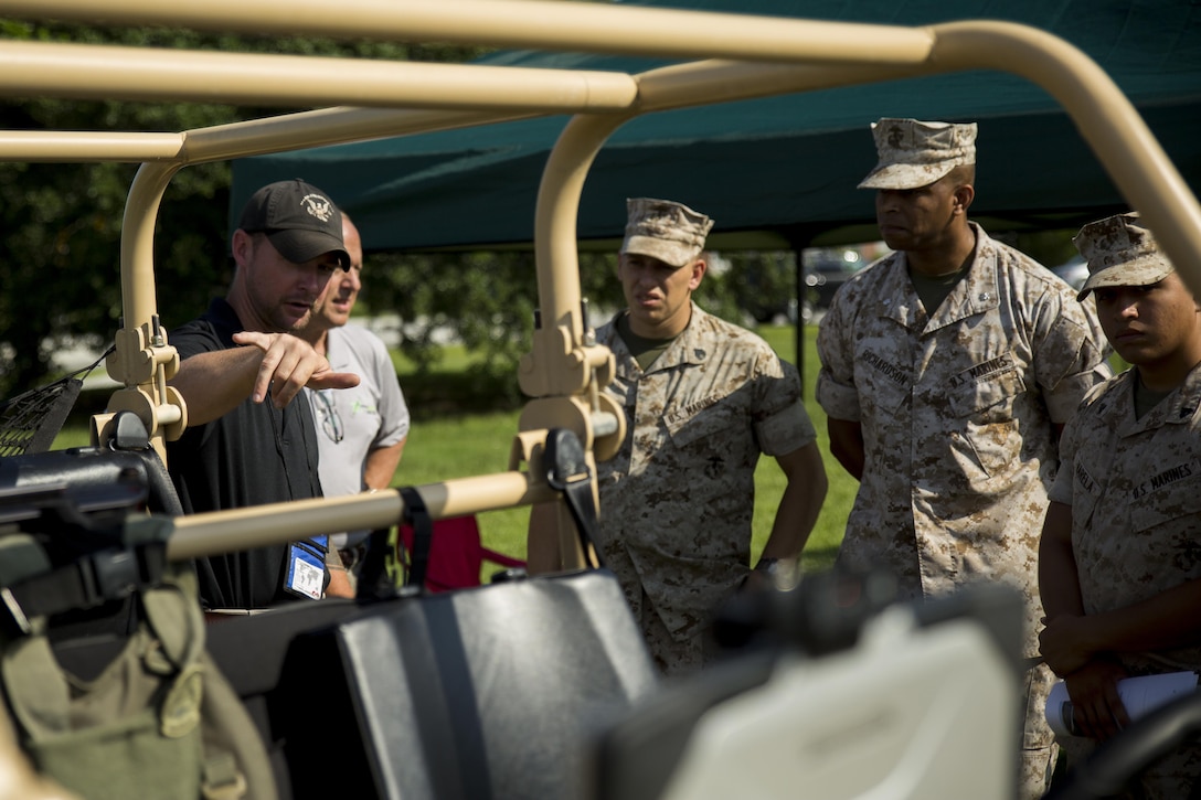 A company representative displays a prototype of an all terrain vehicle at the Expeditionary Energy Concepts demonstration at Marine Corps Base Camp Lejeune, North Carolina, June 23-25, 2015. E2C is an annual event where companies come out and display energy efficient equipment for potential future combat readiness in the Corps. 