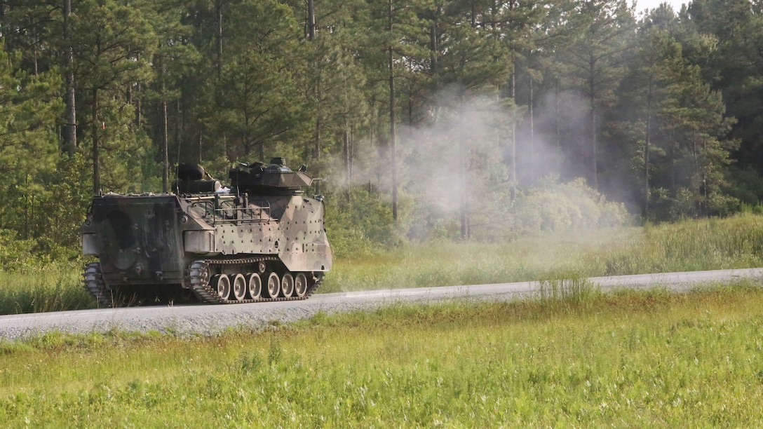Marines with 2nd Assault Amphibian Battalion fire an M2HB .50-caliber machine gun in a live fire training event during a Heavy Brigade Combat Team qualification course aboard Camp Lejeune, N.C., June 19, 2015. During the live fire event, the Marines aimed and shot at moving targets to simulate enemy movement. (U.S. Marine Corps photo by Lance Cpl. Chris Garcia/Released)