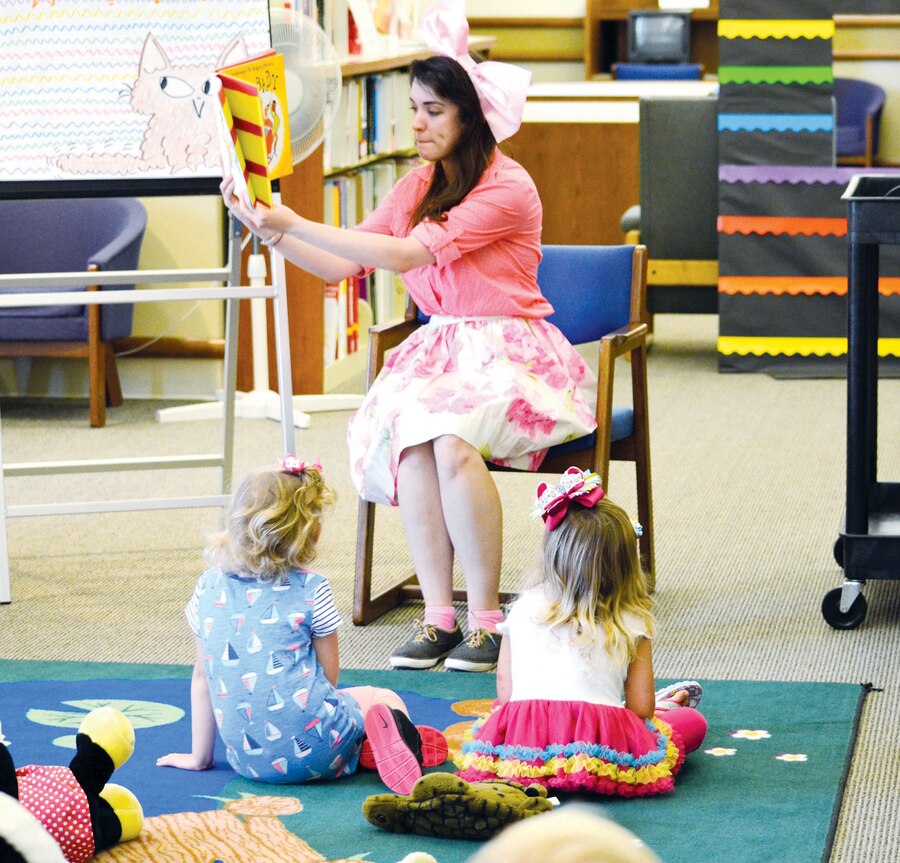 Children’s librarian Kaylee Wilsher reads to children during the toddler story hour that kicked off the summer reading program. This year’s theme is “Read to the Rhythm,” and Kaylee chose the book “Jazz Baby” for the session.