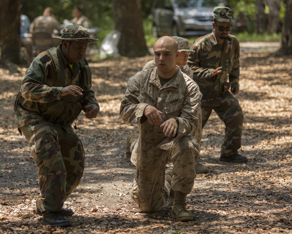 Lance Cpl. Benjamin Swanson, a rifleman with 3rd Battalion, 8th Marine Regiment, works one-on-one with a role player during a patrolling class for a practical application exercise during a pre-deployment certification exercise for Special-Purpose Marine Air-Ground Task Force Crisis Response-Africa on Marine Corps Base Camp Lejeune, N.C., June 19, 2015. Role players acted as host nationals while the Marines with SPMAGTF-CR-AF put what they had learned in classes from the Marine Corps Security Cooperation Group earlier that week to the test. (U.S. Marine Corps photo by Cpl. Olivia McDonald/Released)