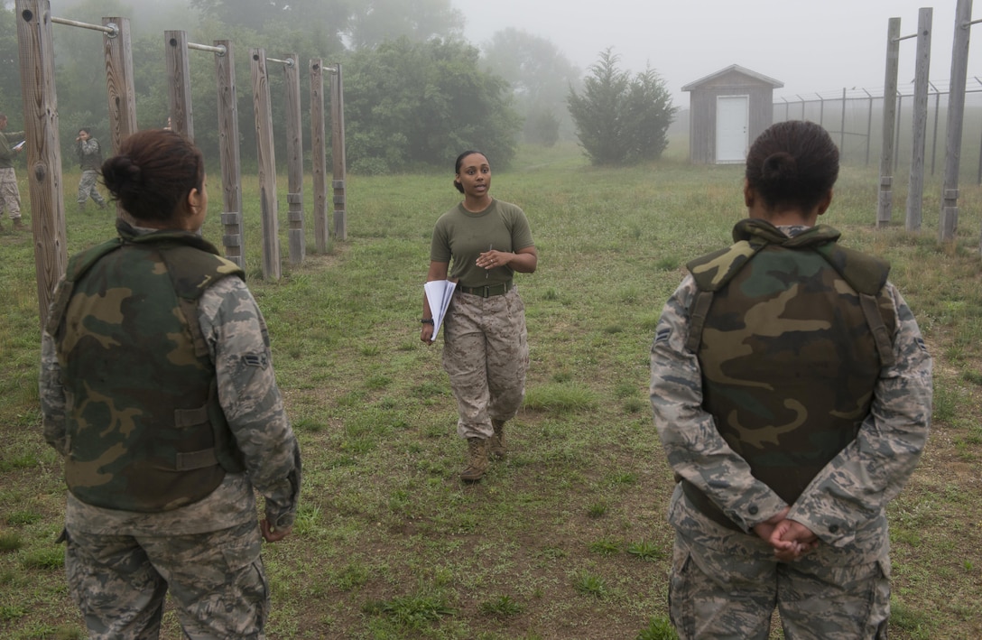 Marine Sgt. Teliah Wilson, the Marine Aircraft Group 49 adjutant and Marine Corps Martial Arts Program course instructor, explains the tan belt MCMAP test to Airmen on Joint Base McGuire-Dix-Lakehurst, N.J., June 16, 2015. Ten Airmen took and passed the course. (U.S. Air Force photo/Airman 1st Class Joshua King) 