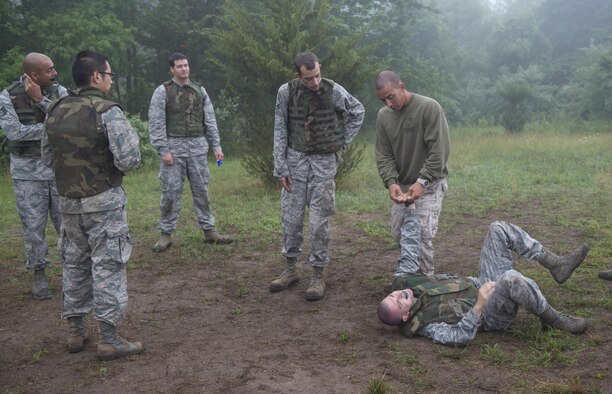 Marine Gunnery Sgt. Lucio Bernabe, assigned to the Marine Aircraft Group 49 and a Marine Corps Martial Arts Program course instructor, demonstrates the final part of a wrist takedown during a MCMAP tan belt class for Airmen on Joint Base McGuire-Dix-Lakehurst, N.J., June 16, 2015. Ten Airmen took and passed the course. (U.S. Air Force photo/Airman 1st Class Joshua King)