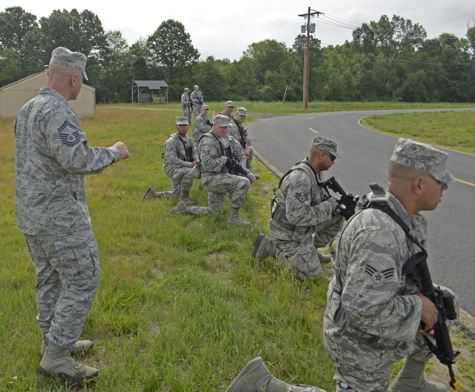 Senior Master Sgt. Anthony Giardini provides guidance to Airmen getting in position to deal with "intruders" driving a stray vehicle. SMSgt. Giardini is the operations superintendent with the 439th Security Forces Squadron. He, among other senior leadership, helped the June 19 exercise run smoothly. (U.S. Air Force photo by Master Sgt. Andrew Biscoe/Released).