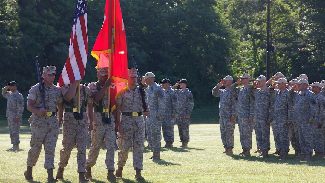 A Marine color guard marches during the opening ceremony of the 54th Interservice Rifle Championship at Marine Corps Base Quantico, Virginia, June 24, 2015. The matches were established in 1960 to promote the competition-in-arms program, which was established during 1901 to encourage interest and improvement in marksmanship by refining skills through advanced marksmanship training and competition.