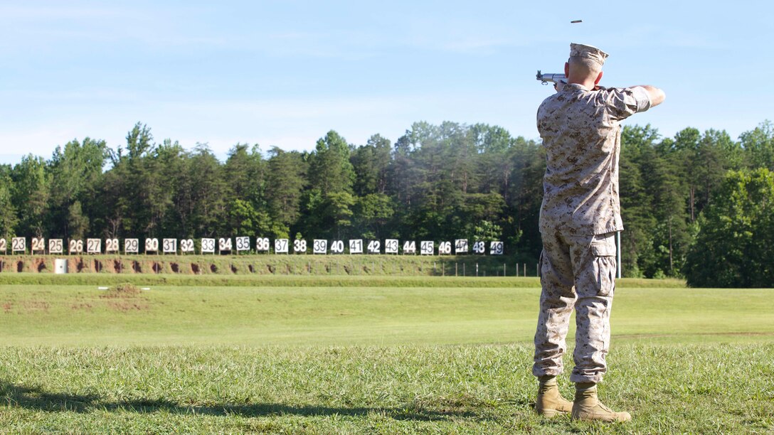 Lieutenant Gen. Mark A. Brilakis fires the first shot with an M1 Garand during the opening ceremony of the 54th Interservice Rifle Championship matches at Marine Corps Base Quantico, Virginia, June 24, 2015. Service members from all branches will compete in 15 different shooting matches during the championships from June 25 – July 1. Lt. Gen. Brilakis is the commanding general of Marine Corps Recruiting Command, and deputy commandant, Manpower and Reserve Affairs. 