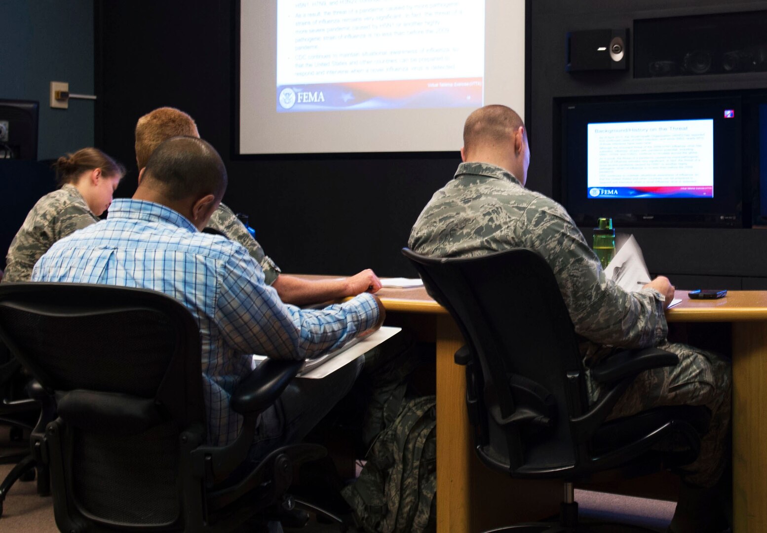 59th Medical Wing Emergency Management and Public Health officers participate in a Virtual Table Top Exercise hosted by the Federal Emergency Management Agency and Center for Disease Control, Atlanta, at the Wilford Hall Ambulatory Surgical Center, Joint Base San Antonio-Lackland, June 2, 2015. The exercise focused on a simulated pandemic influenza outbreak, providing agencies through the U.S. a chance to collaborate on emergency response plans. (U.S. Air Force photo / Technical Sgt. Christopher Carwile/Released)