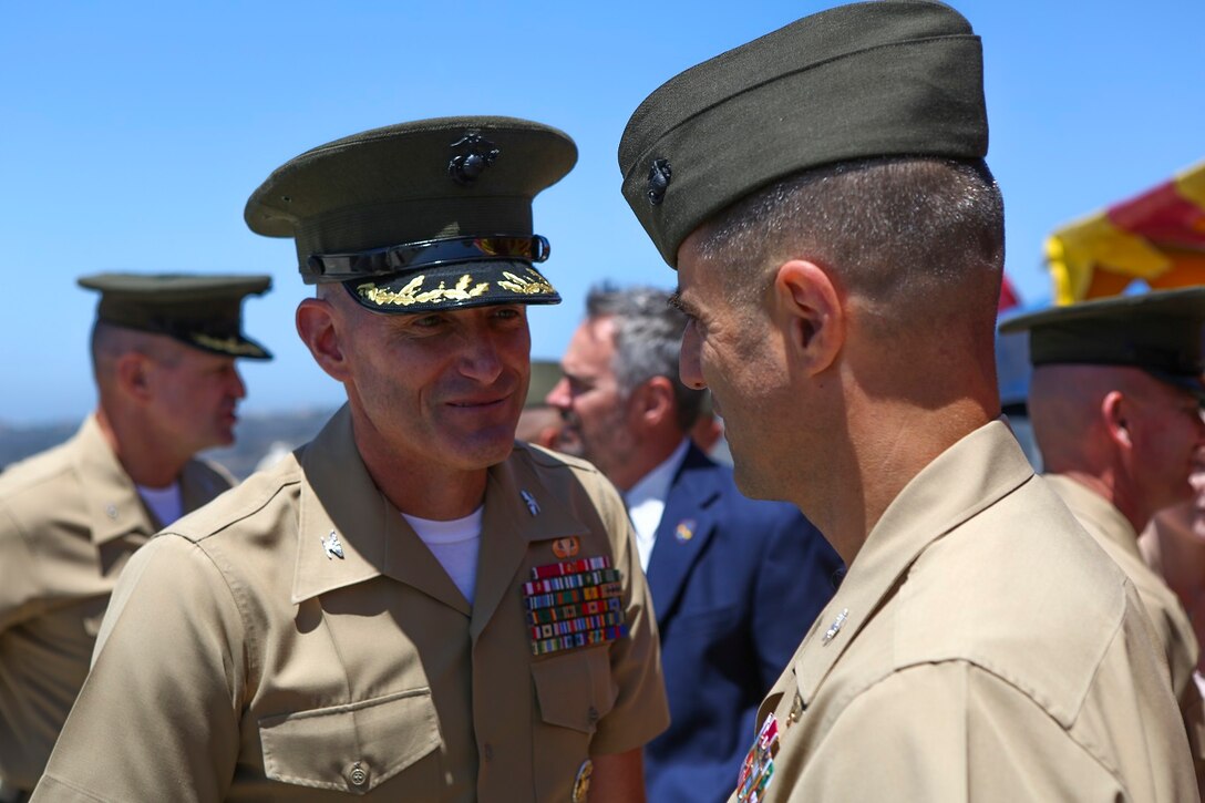 Colonel Jason Q. Bohm is congratulated by Marines and Sailors after relinquishing his role as the commanding officer of the 5th Marine Regiment to Col. Kenneth R. Kassner aboard Marine Corps Base Camp Pendleton, Calif., June 24, 2015. Kassner most recently served as the assistant chief of staff, programming and requirements, U.S. Marine Corps Forces Special Operations Command.