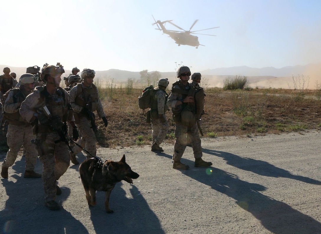 Marines with 1st Explosive Ordnance Disposal Company, 1st Marine Logistics Group, I Marine Expeditionary Force, disembark a CH-53 Super Stallion helicopter and move to their mission objective, where they were tasked with destroying ordnance fired at a foreign embassy during a training exercise aboard Camp Pendleton, Calif., June 17, 2015. The Marines of 1st EOD Co. are preparing for an upcoming deployment with Special Purpose Marine Air Ground – Crisis Response – Central Command, where they will participate in a fast reaction force role.