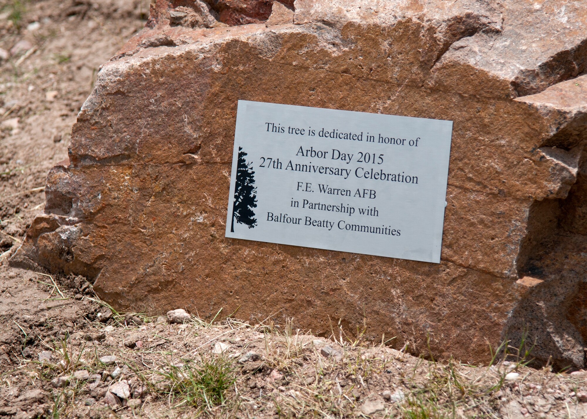 A plaque affixed to a rock representing the 27th consecutive year of F.E. Warren Air Force Base, Wyo., participation in the Tree City USA program. Four criteria must be met for a community to be called a Tree City USA: they must have a tree board or department, a tree care ordinance, a community forestry program with an annual budget of at least $2 per capita and an Arbor Day observance and proclamation. (U.S. Air Force photo by Airmen 1st Class Malcolm Mayfield)