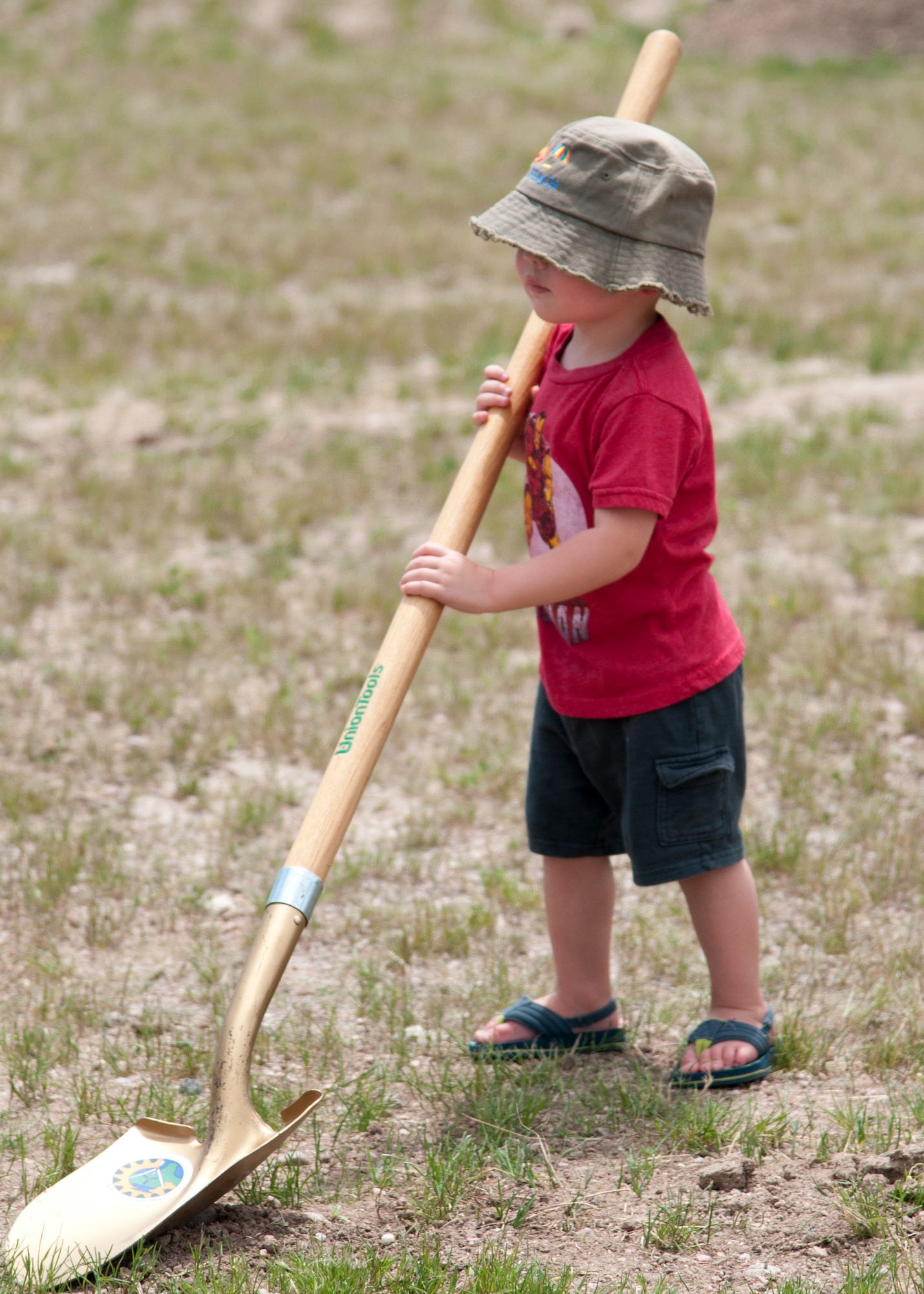 Aceson Heuck, 1, son of Senior Airmen Anthony Heuck, 90th Maintenance Operations Squadron vehicle and equipment section technician, helps out with the 90th Missile Wing’s 27th Arbor Day tree-planting event June 24, 2015, on F.E. Warren Air Force Base, Wyo. (U.S. Air Force photo by Airmen 1st Class Malcolm Mayfield)