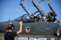 Luke Hastings, son of Col. Brian Hastings, 47th Flying Training Wing commander, marshals his father’s aircraft after Col. Hastings’ final flight at Laughlin Air Force Base, Texas, June 25, 2015. In preparation for Hasting’s change of command ceremony set to occur on Monday, June 29, he completed his “fini flight” with Lt. Col. Joshua Lechowick, 47th Operations Group deputy commander, in the T-38 Talon. (U.S. Air Force photo by Airman 1st Class Brandon May)