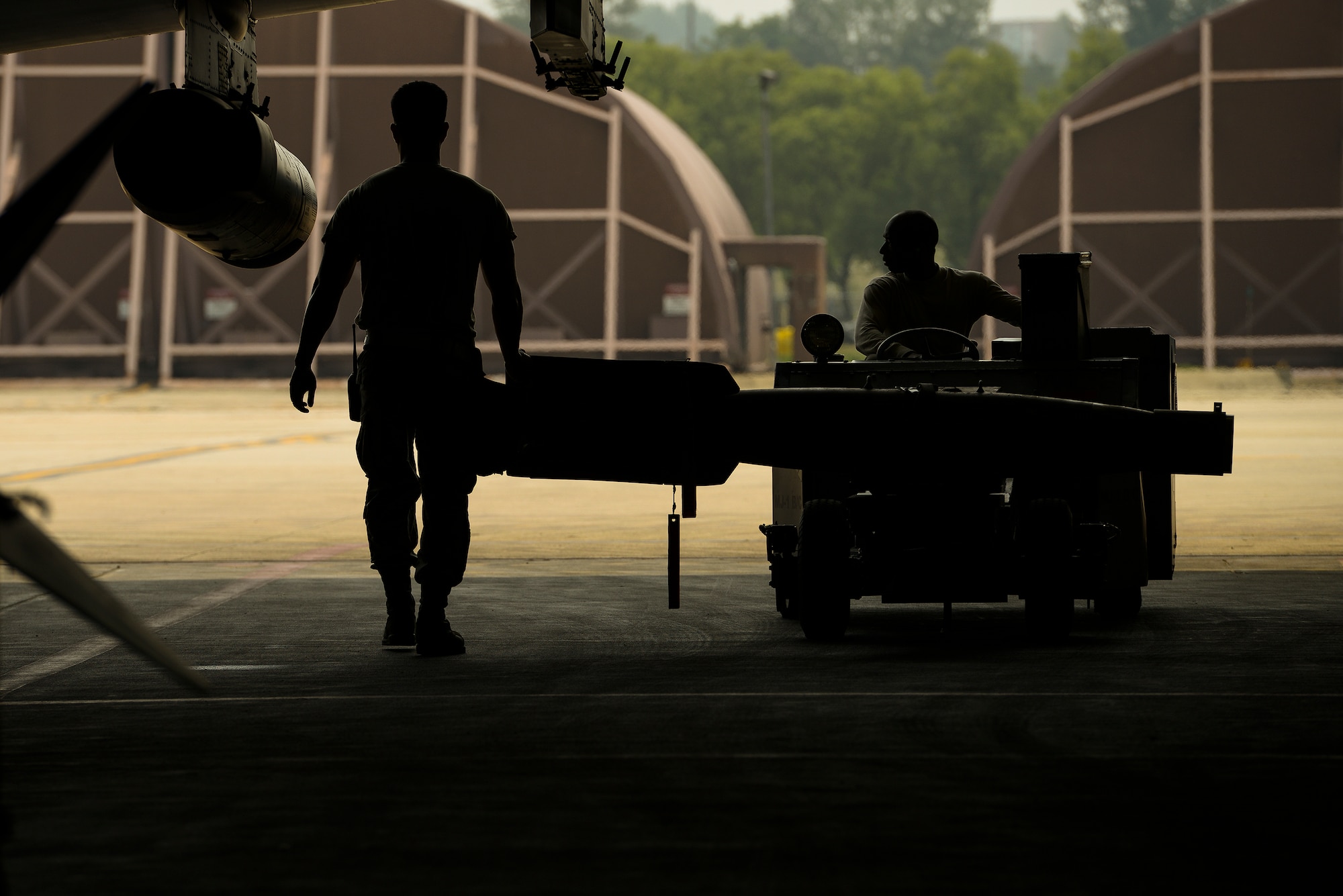 Airmen from the 25th Aircraft Maintenance Unit move a missle before sortie launches June 23, 2015, at Osan Air Base, Republic of Korea. The weapons section moves the weapons in order to mantain a balance across the fleet in each bay. (U.S. Air Force photo by Staff Sgt. Jake Barreiro/Released)