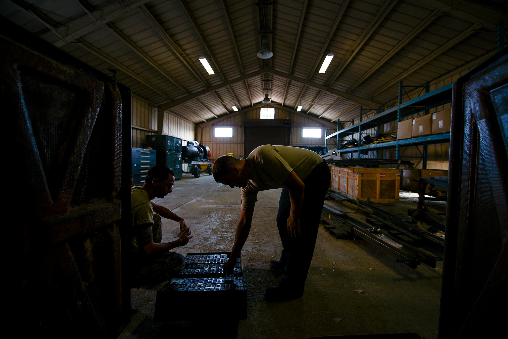 Staff Sgt. Christopher Simison, 25th Aircraft Maintenance Unit weapons load team chief, inspects materials in storage June 22, 2015, at Osan Air Base, Republic of Korea. Simison and others weapons Airmen are responsible for inventory and the proper storage of equipment, which can be inspected by the unit's quality assurance personnel. (U.S. Air Force photo by Staff Sgt. Jake Barreiro/Released)
